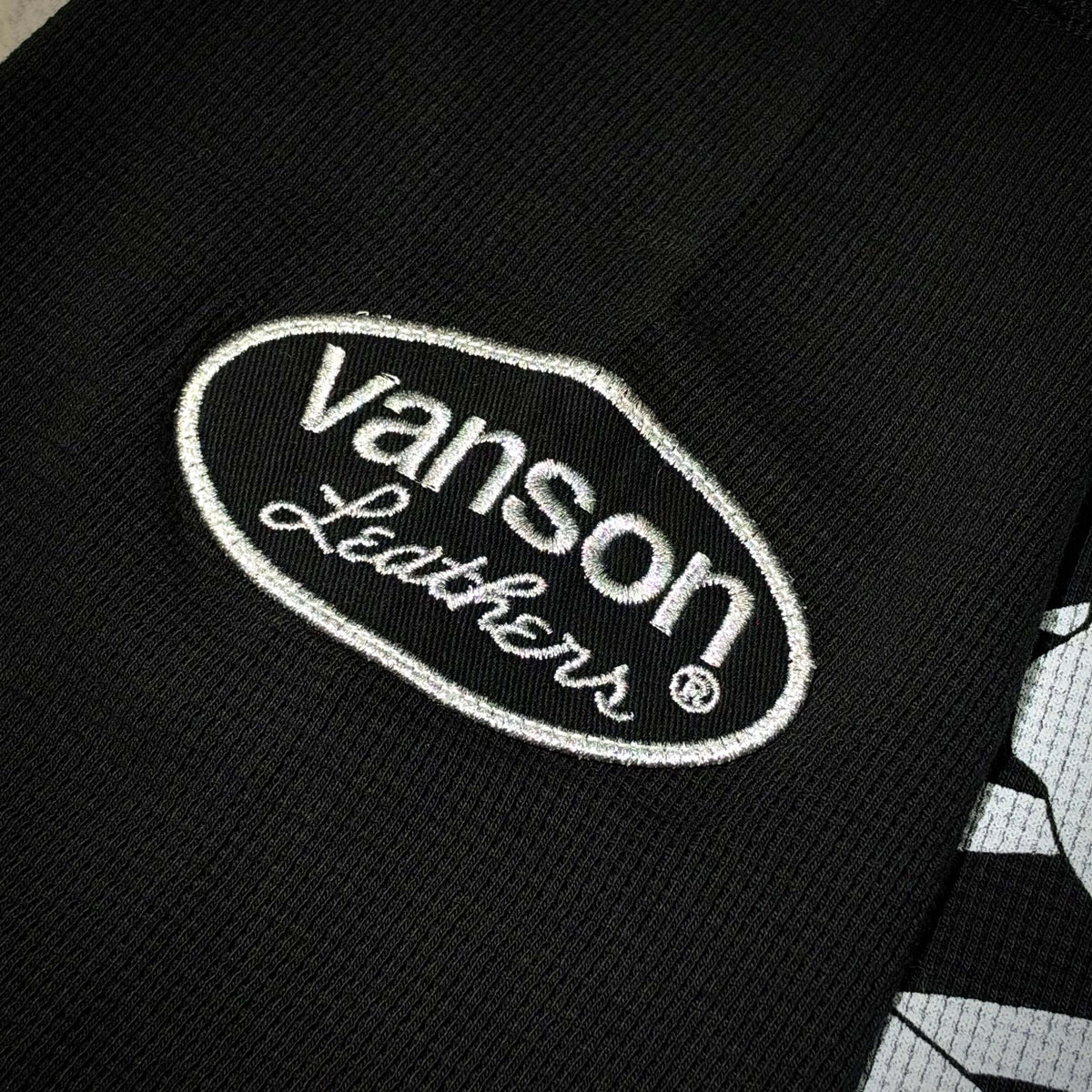 Close-up of the Vanson Leathers logo embroidered on the Mastermind World x Vanson Regular Fit Tee.