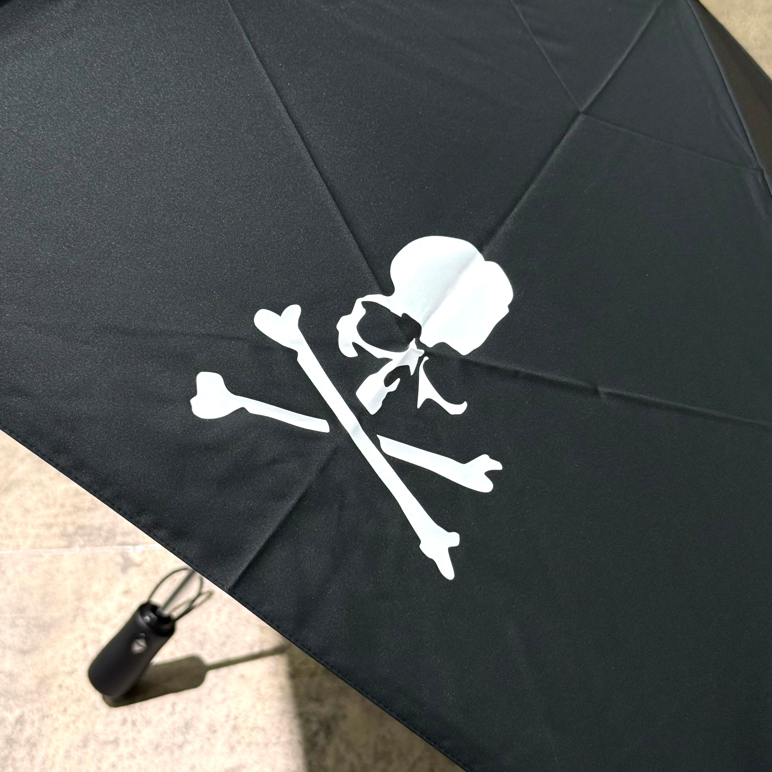 Mastermind Japan Moonrakers Umbrella featuring a skull and crossbones design on a black canopy.