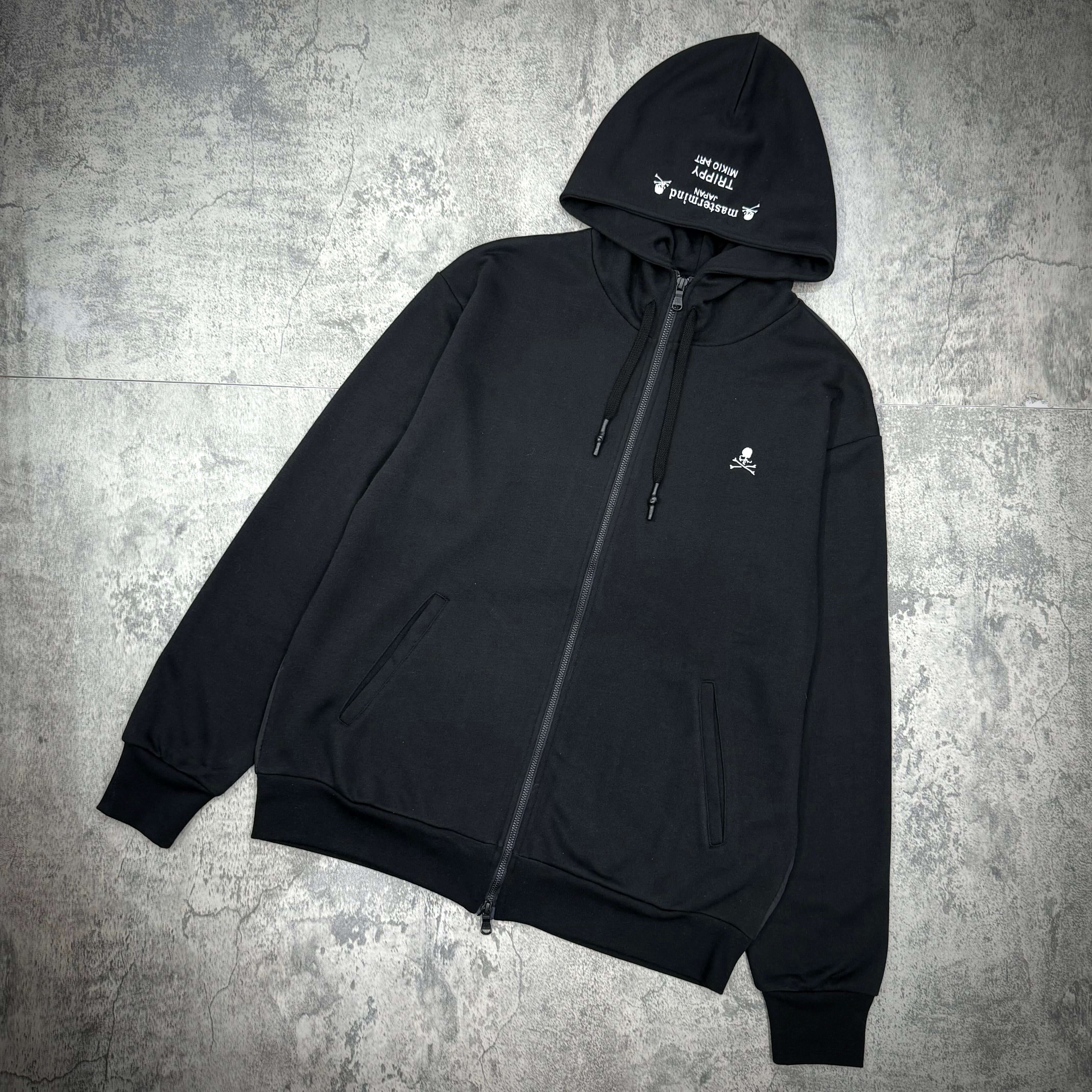 Mastermind Japan x Trippy Art Rock Star Zip Up hoodie featuring a black design and zip closure.