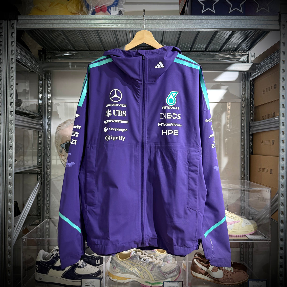Mercedes-AMG Petronas Formula 1 Team Vanda Bloom Rain Jacket HZ9485 displayed in a shop.