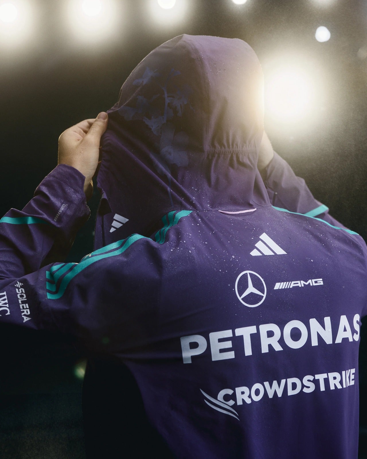 Mercedes-AMG Petronas Formula 1 Team Vanda Bloom Rain Jacket HZ9485 worn with hood up, showcasing design details.