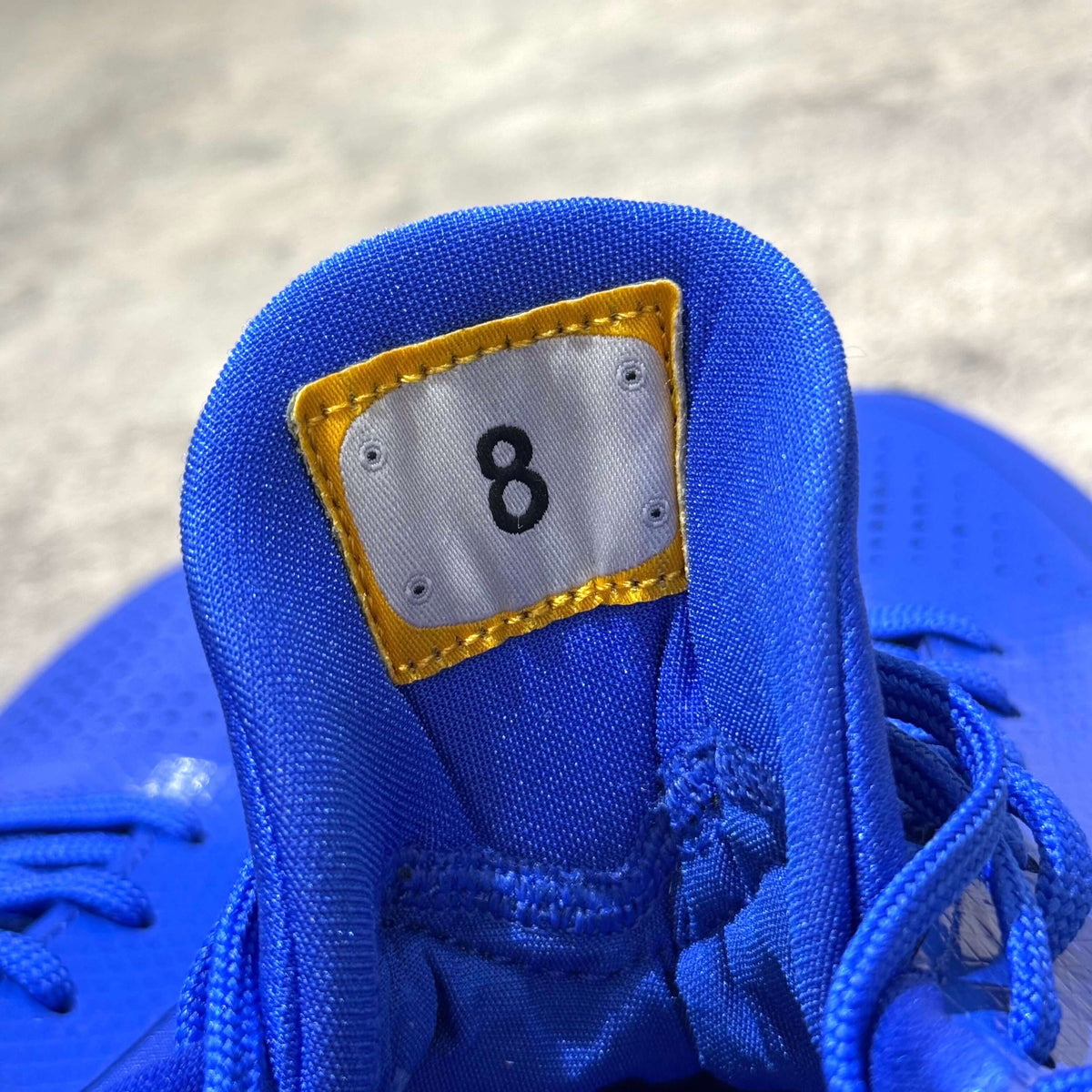 Inside view of Nike Zoom Kobe 5 Protro Dodgers showing tag with number 8, highlighting the shoe's unique design features.