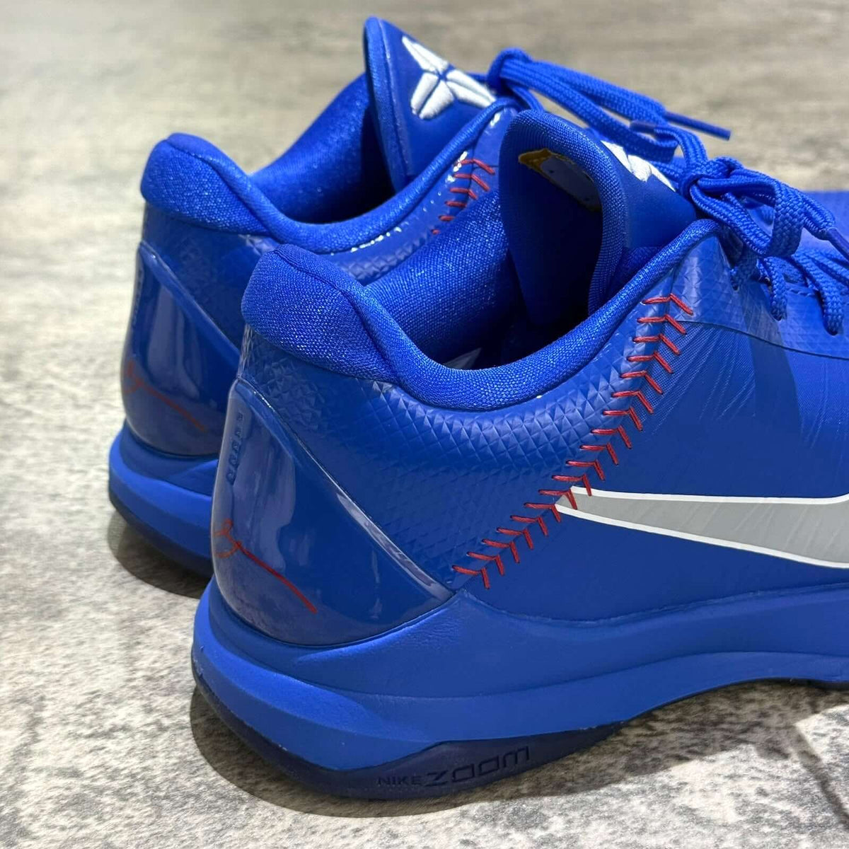 Nike Zoom Kobe 5 Protro Dodgers IO6256-400 blue sneaker rear view with red stitching and the signature logo.
