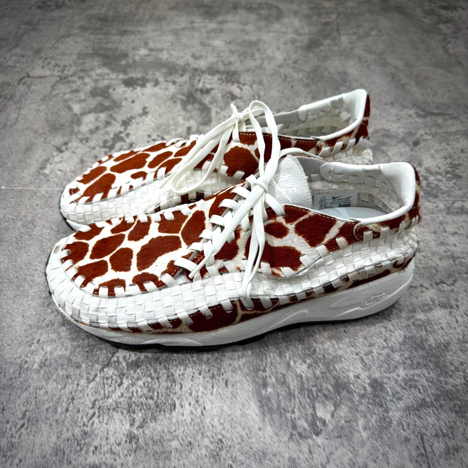 Nike Air Footscape Woven Cow Print sneakers featuring a unique cow print design.