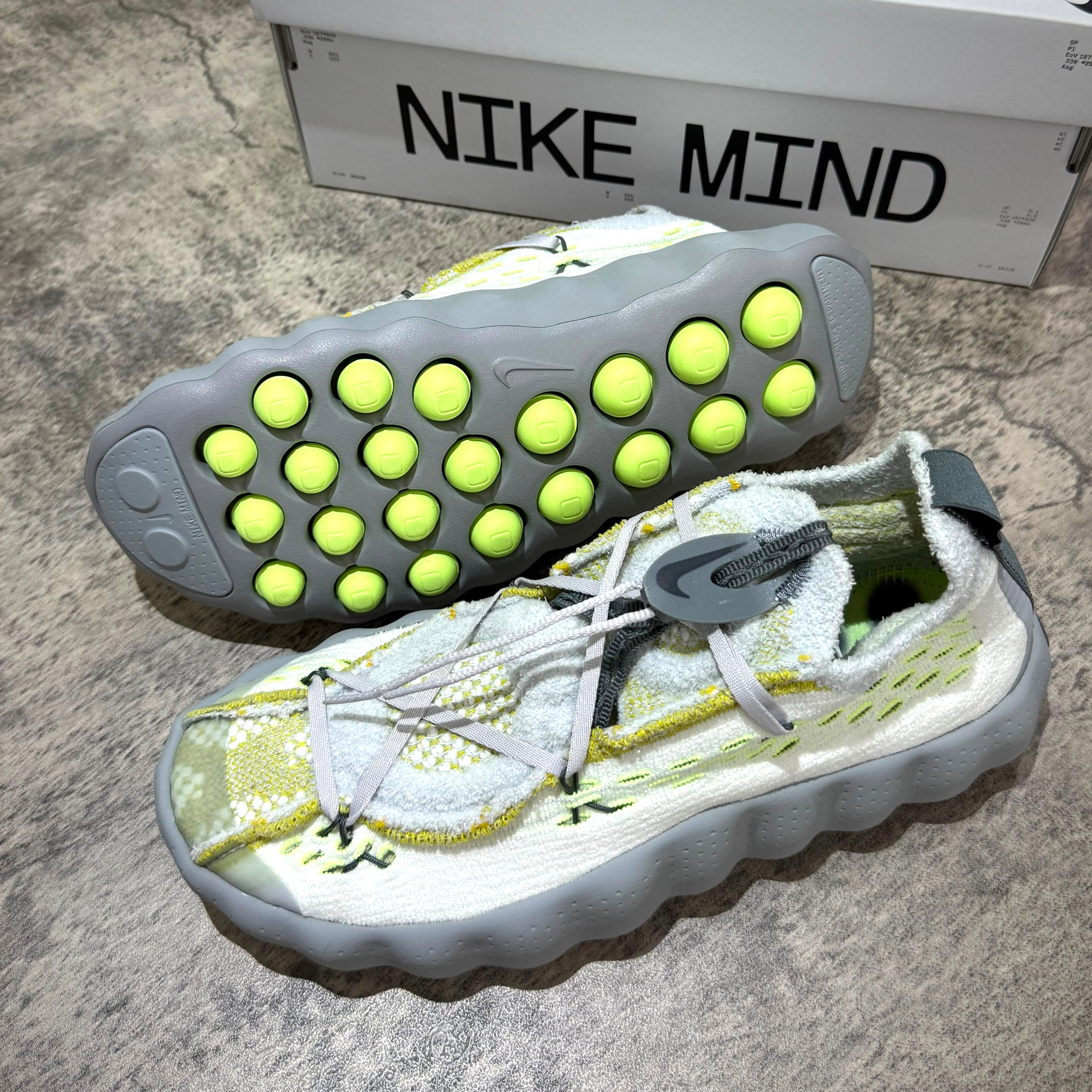 Nike Mind 002 Flyknit - Wolf Grey sneaker with unique sole design and vibrant details.
