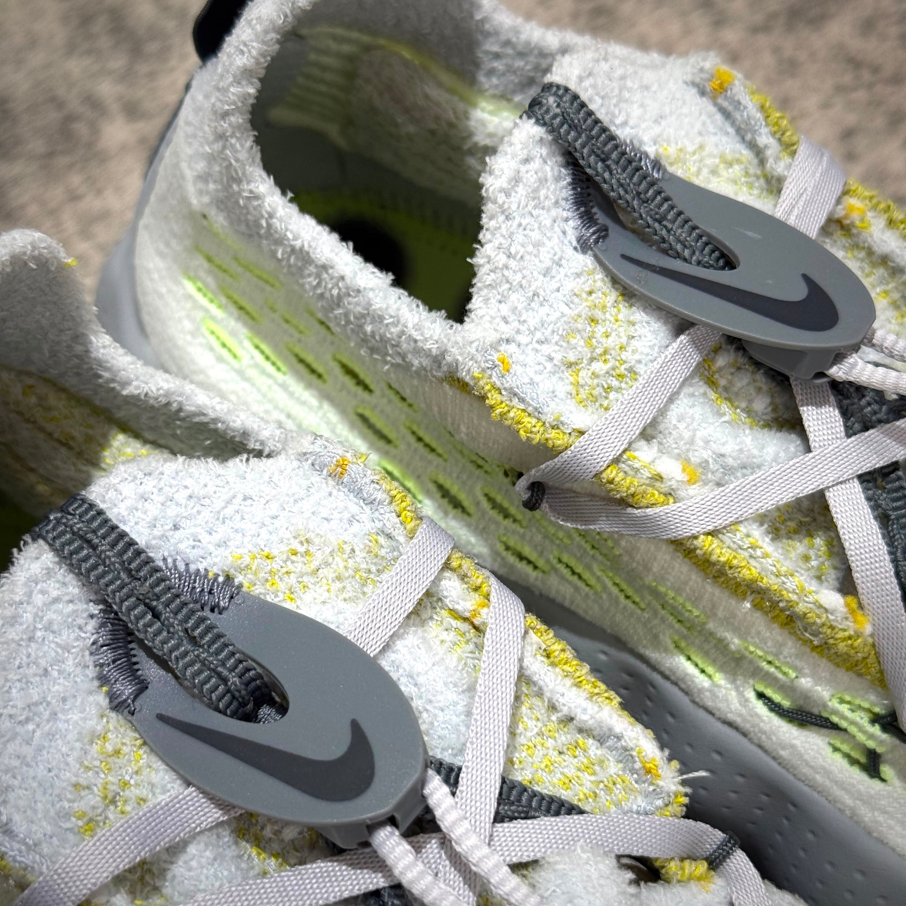 Nike Mind 002 Flyknit - Wolf Grey close-up showcasing details of the shoe's design and lacing system.