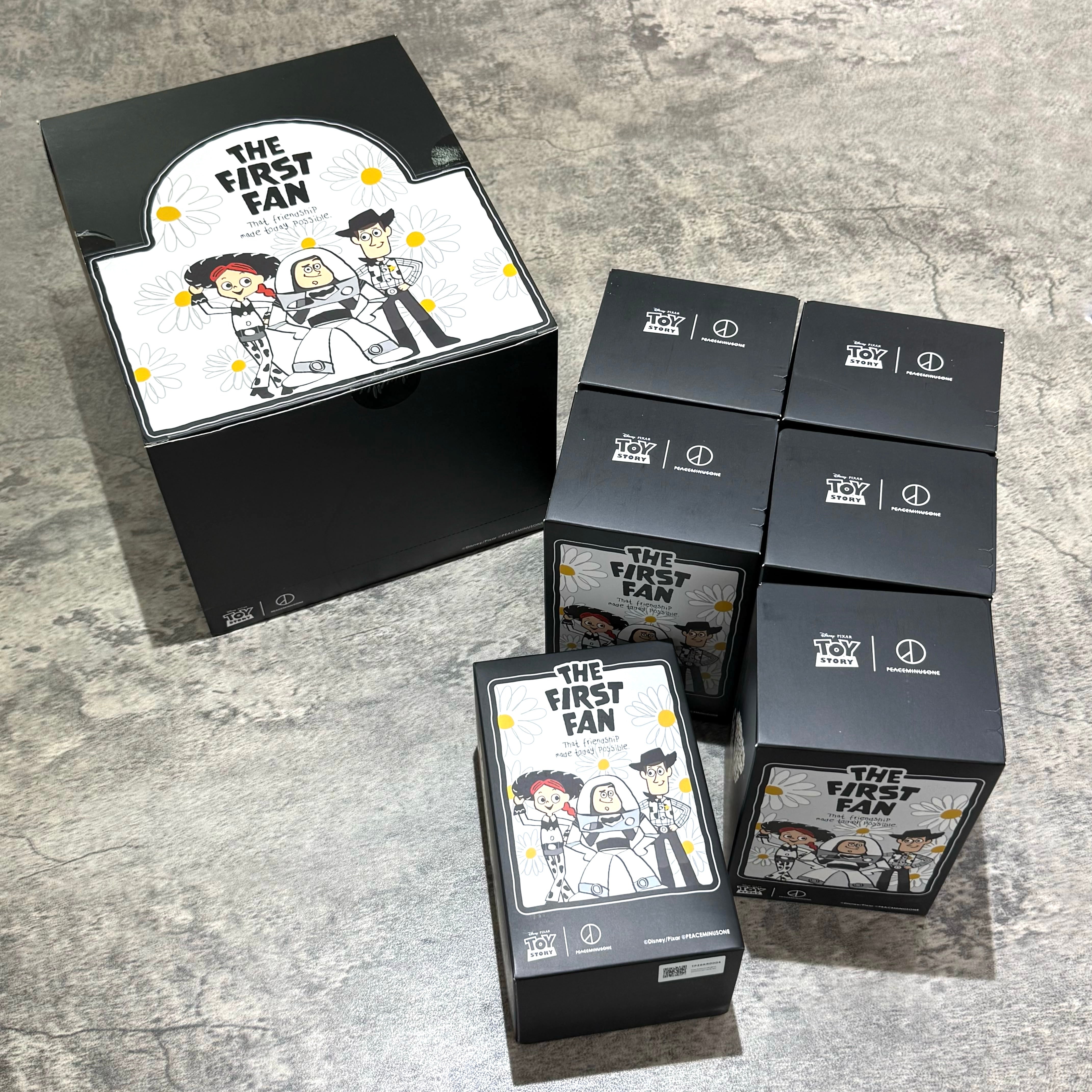 PEACEMINUSONE x Toy Story The First Fan blind box plush key ring packaging displayed on a gray surface.