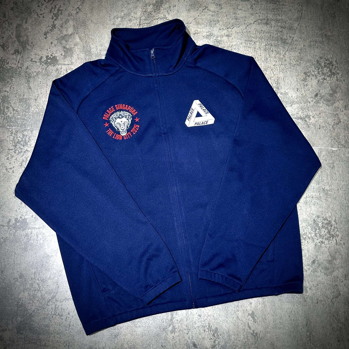 Palace Singapore Jacket showcasing navy design with lion graphic and Palace logo.