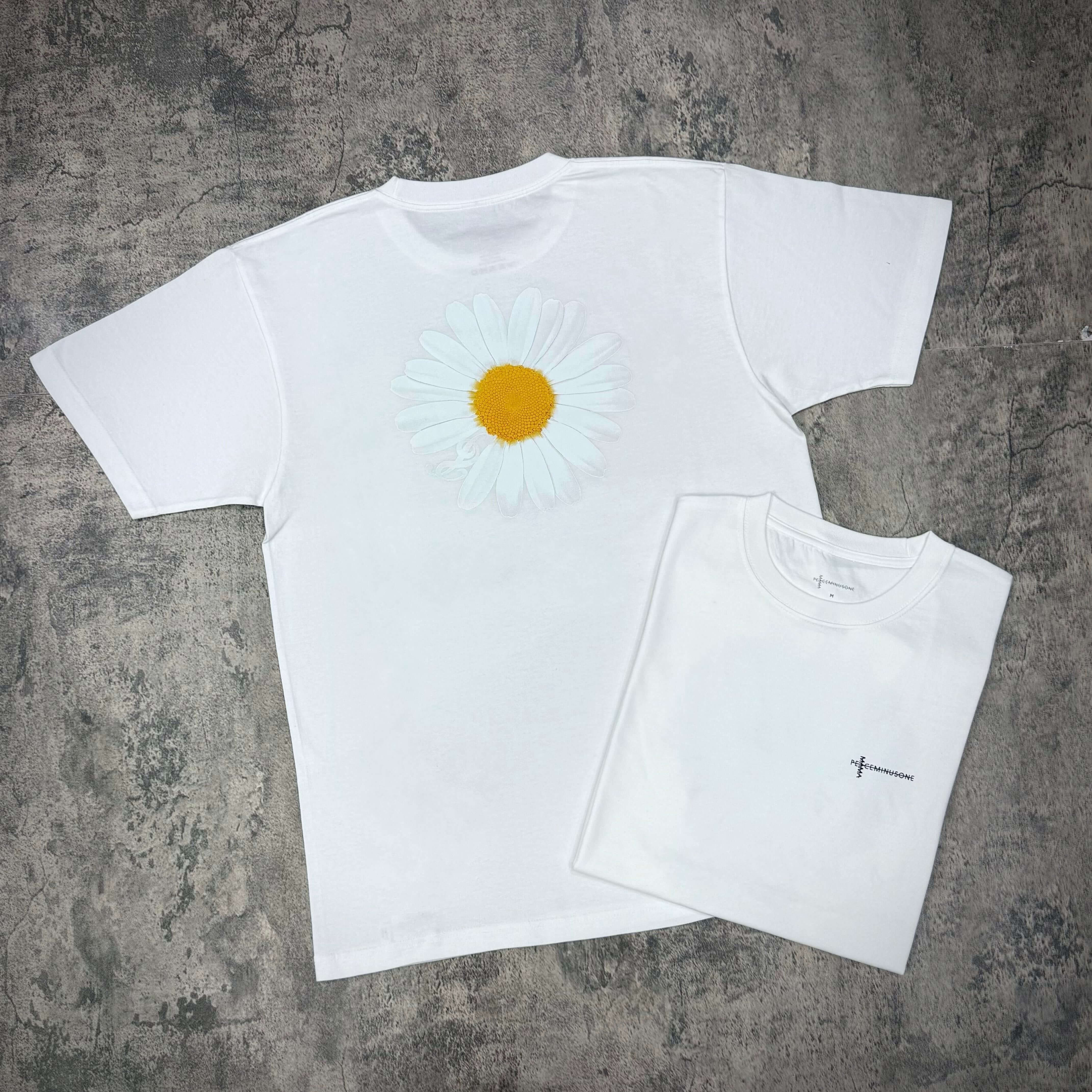 Peaceminusone G Dragon x 2025 MAMA Awards Tee featuring a white shirt with a flower design and a folded shirt.