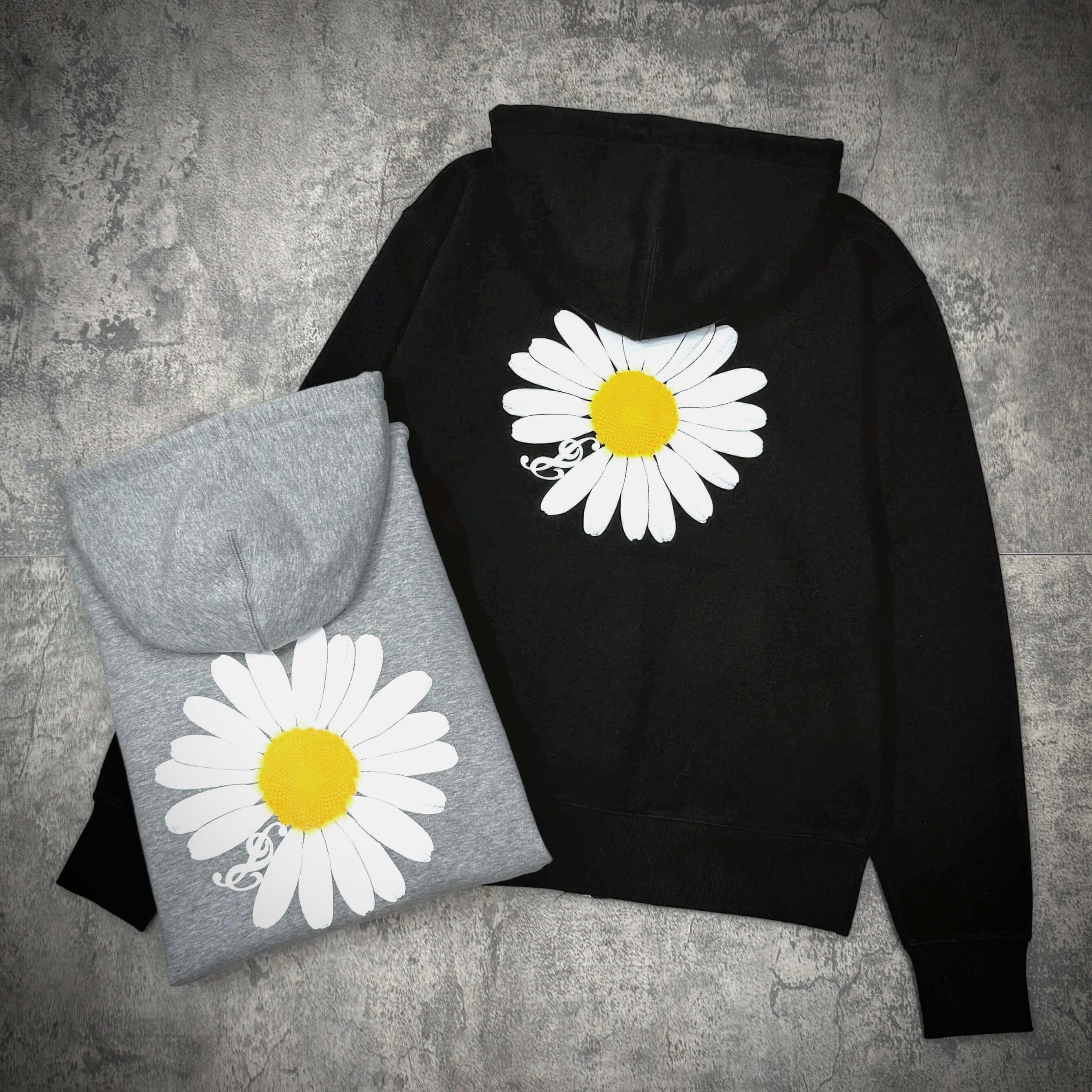 Peaceminusone G Dragon x 2025 MAMA Awards Zip Up featuring daisy design on black and grey hoodies.