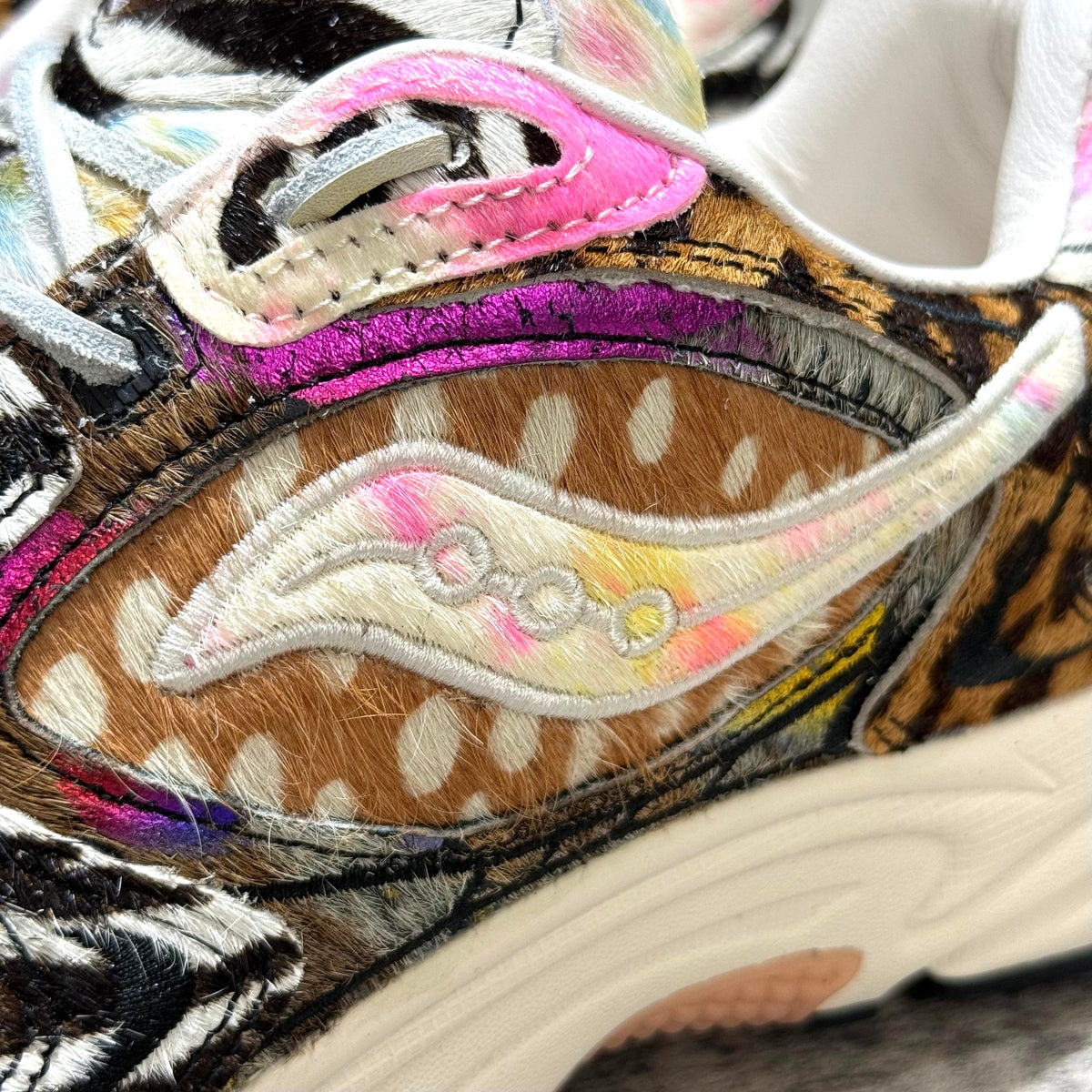 Close-up of Saucony x Westside Gunn Grid Jazz 9 Awesome God sneaker highlighting unique textures and vibrant colors. wear43way