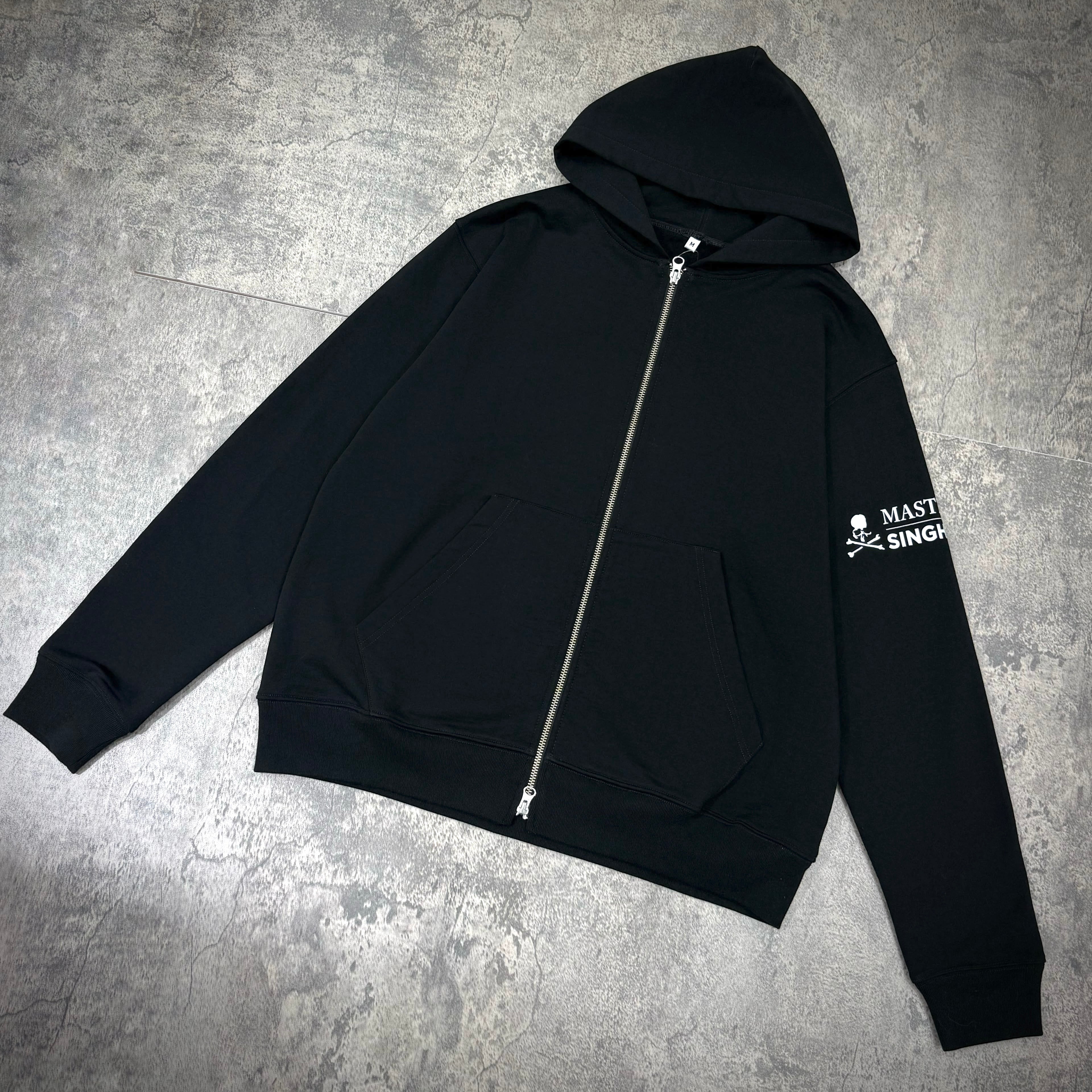 Singha Soda x Mastermind World Zip Up Hoodie in black with front pocket and hood.