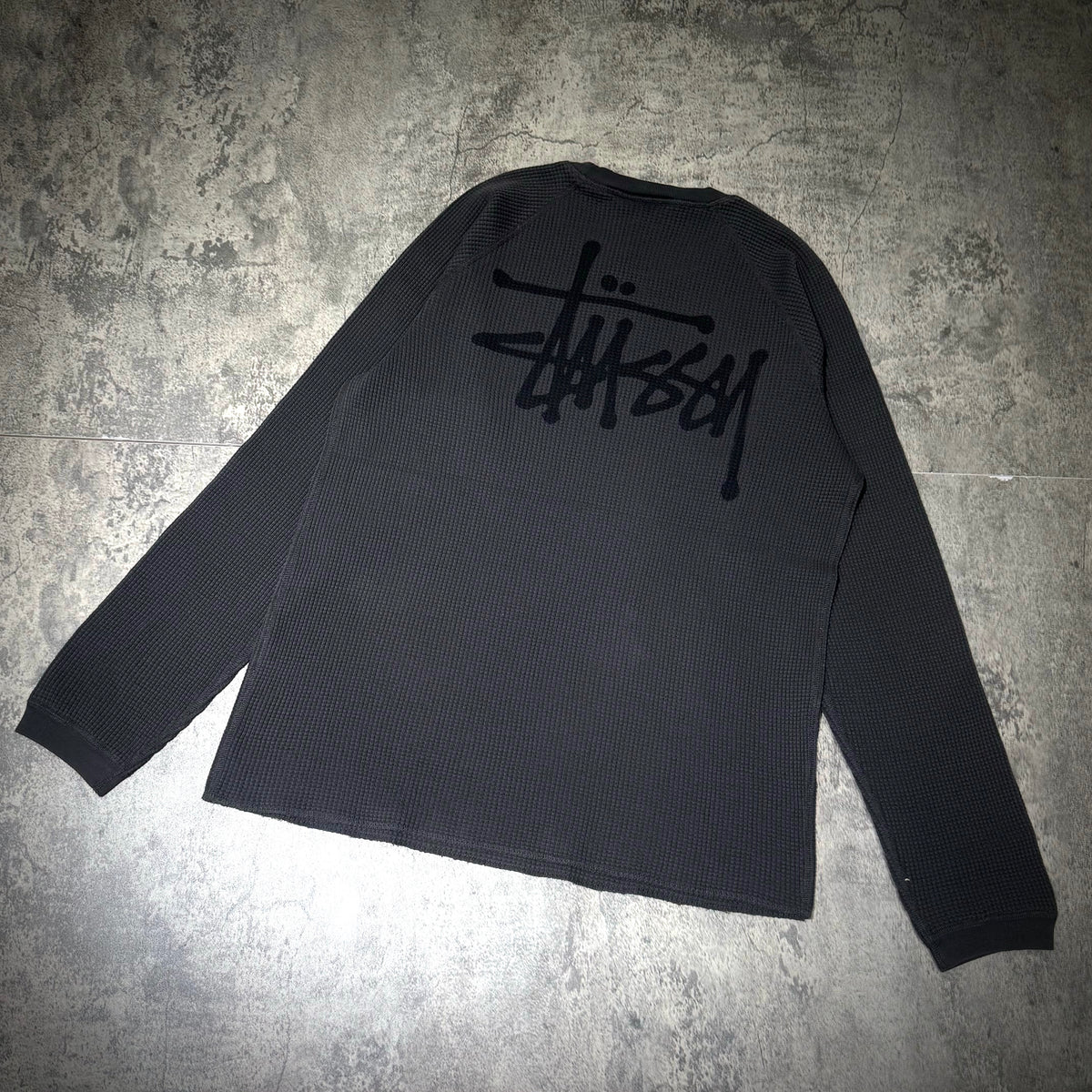Back view of black Stussy Basic Raglan Thermal LS Crew FW26 with signature logo.