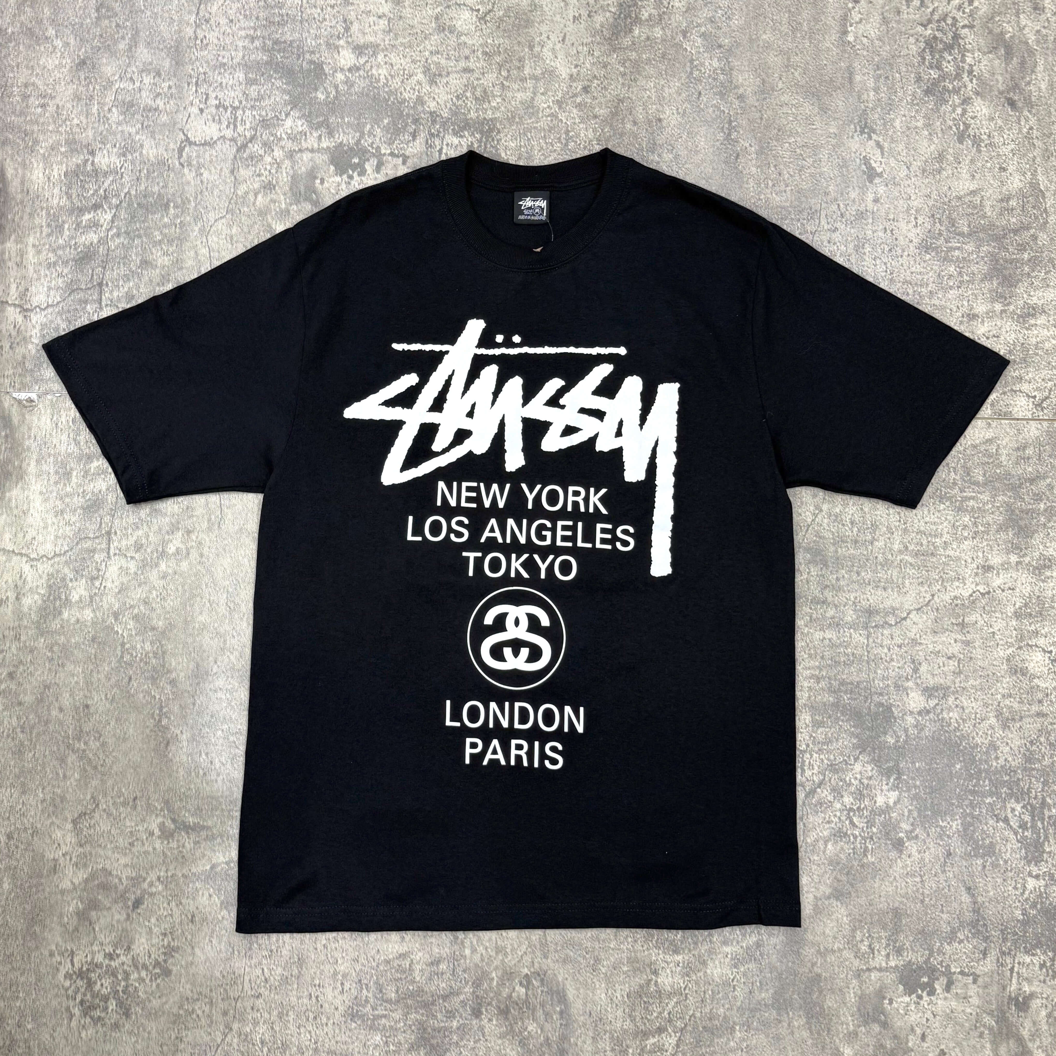 現貨 Stussy World Tour Tee - Navy / Black / White，展示正品Stussy設計，包含紐約、洛杉磯、東京、倫敦、巴黎城市名