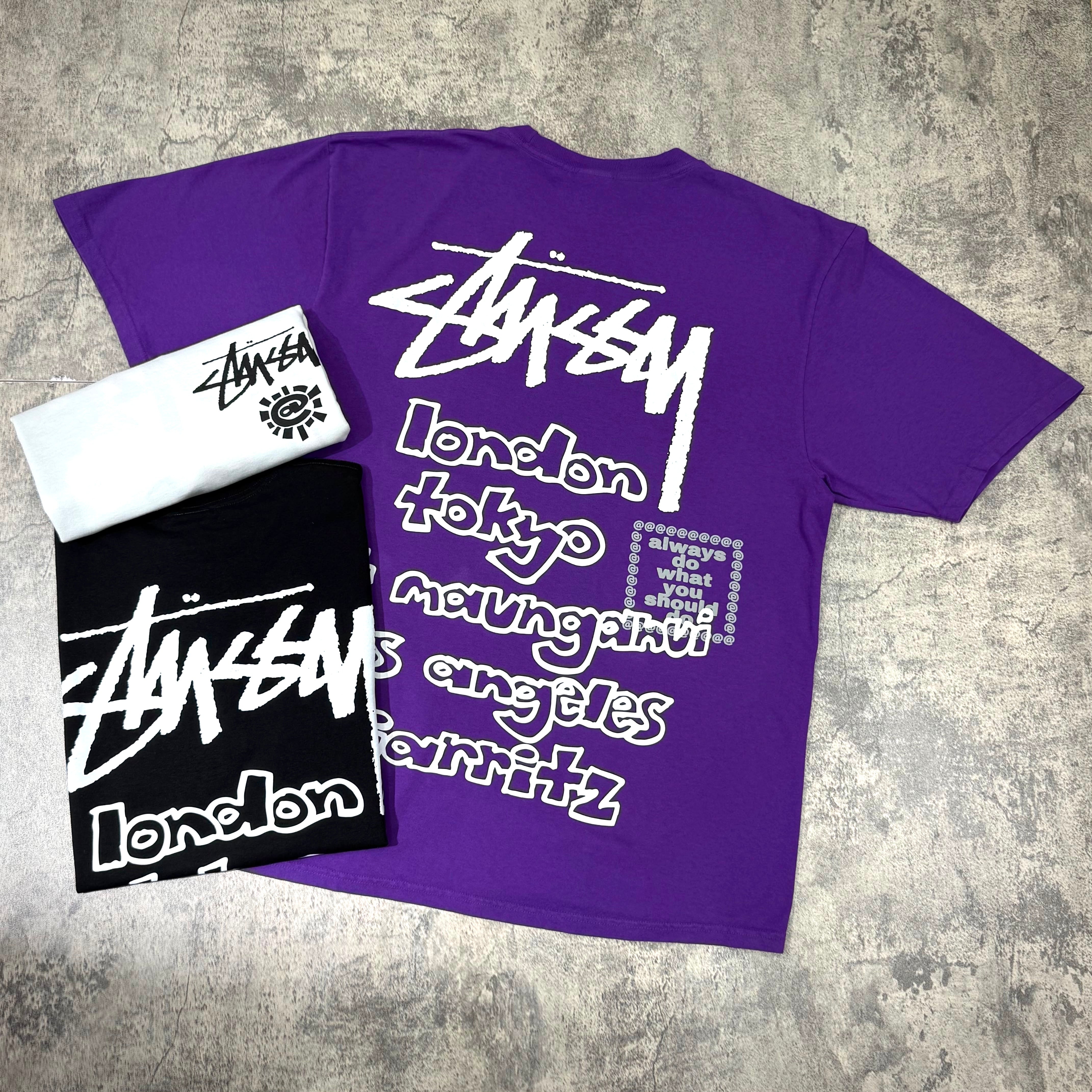 Stussy x Always Do What You Should Do World Tour Tee in purple, black, and white with city graphics