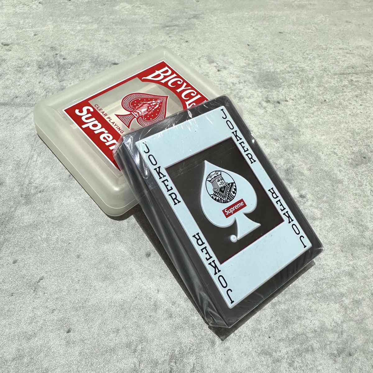 Supreme Bicycle Clear Playing Cards Red in packaging with Joker card design.