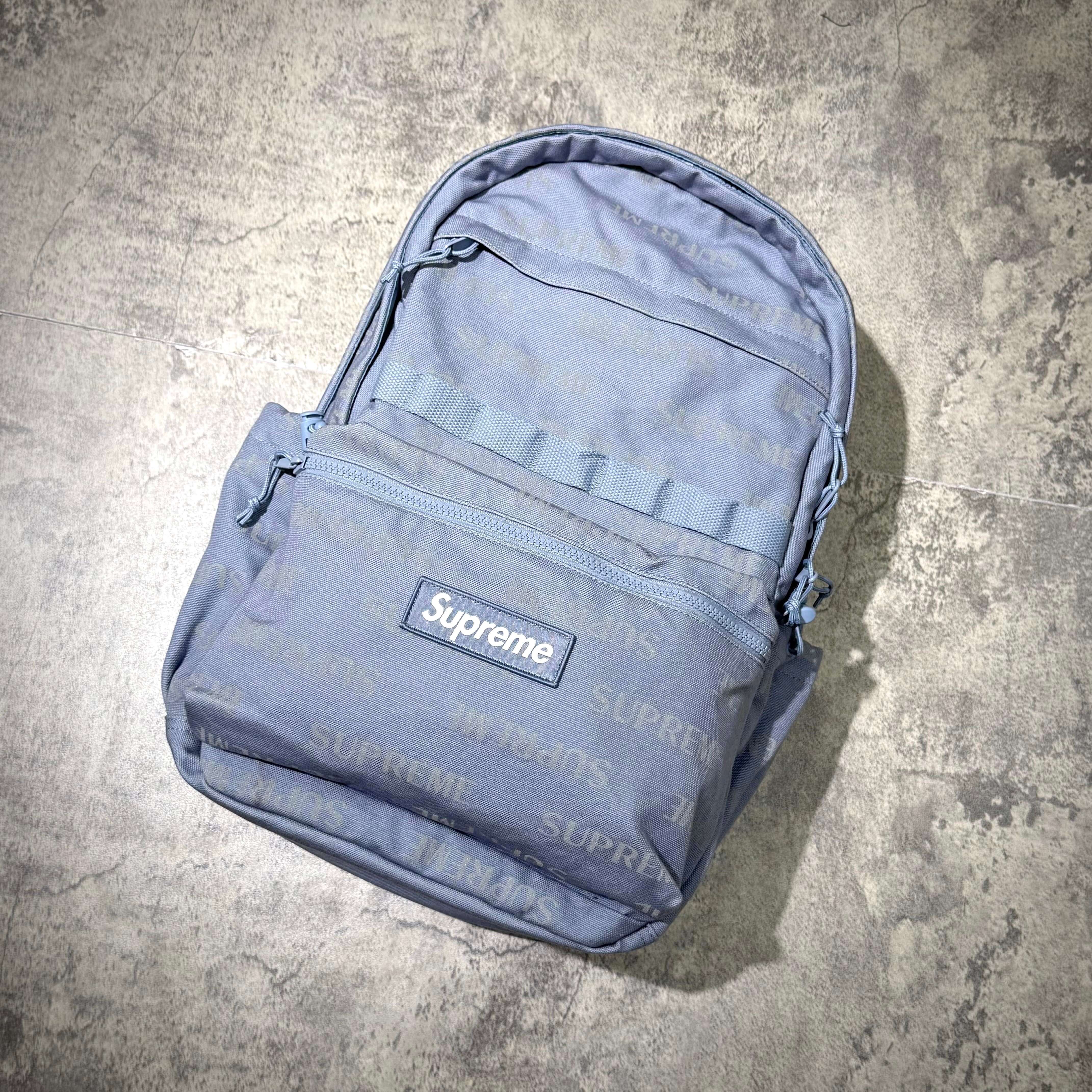 Supreme FW26 Backpack displayed on a textured surface, showcasing its stylish design and quality craftsmanship.