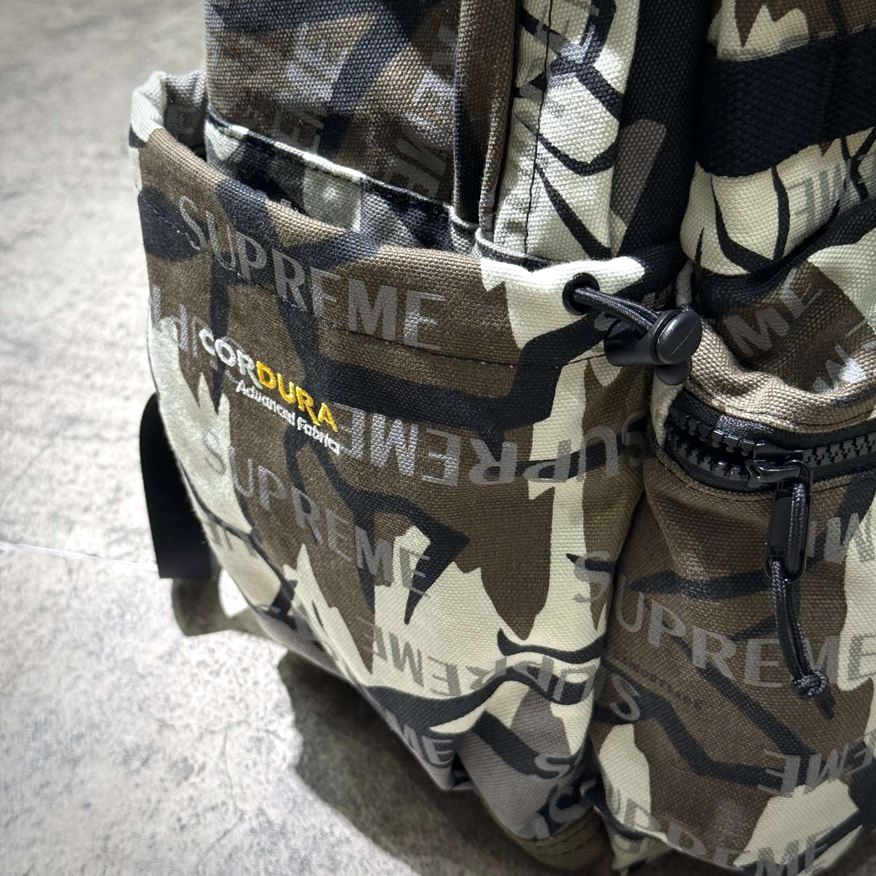 Supreme FW26 Backpack featuring camouflage design and Cordura fabric for durability.