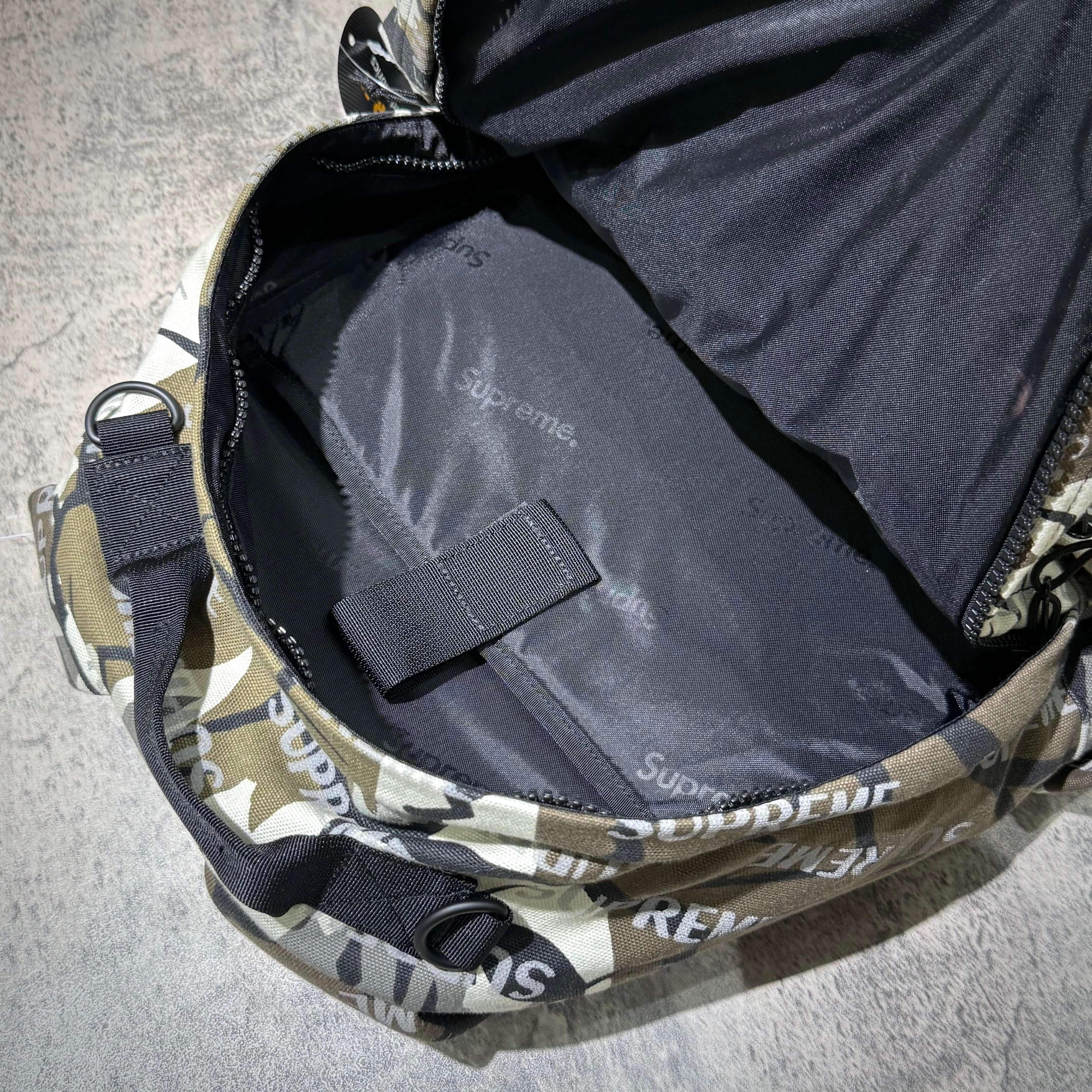 Inside view of the Supreme FW26 Backpack showing spacious black lining and printed logo.