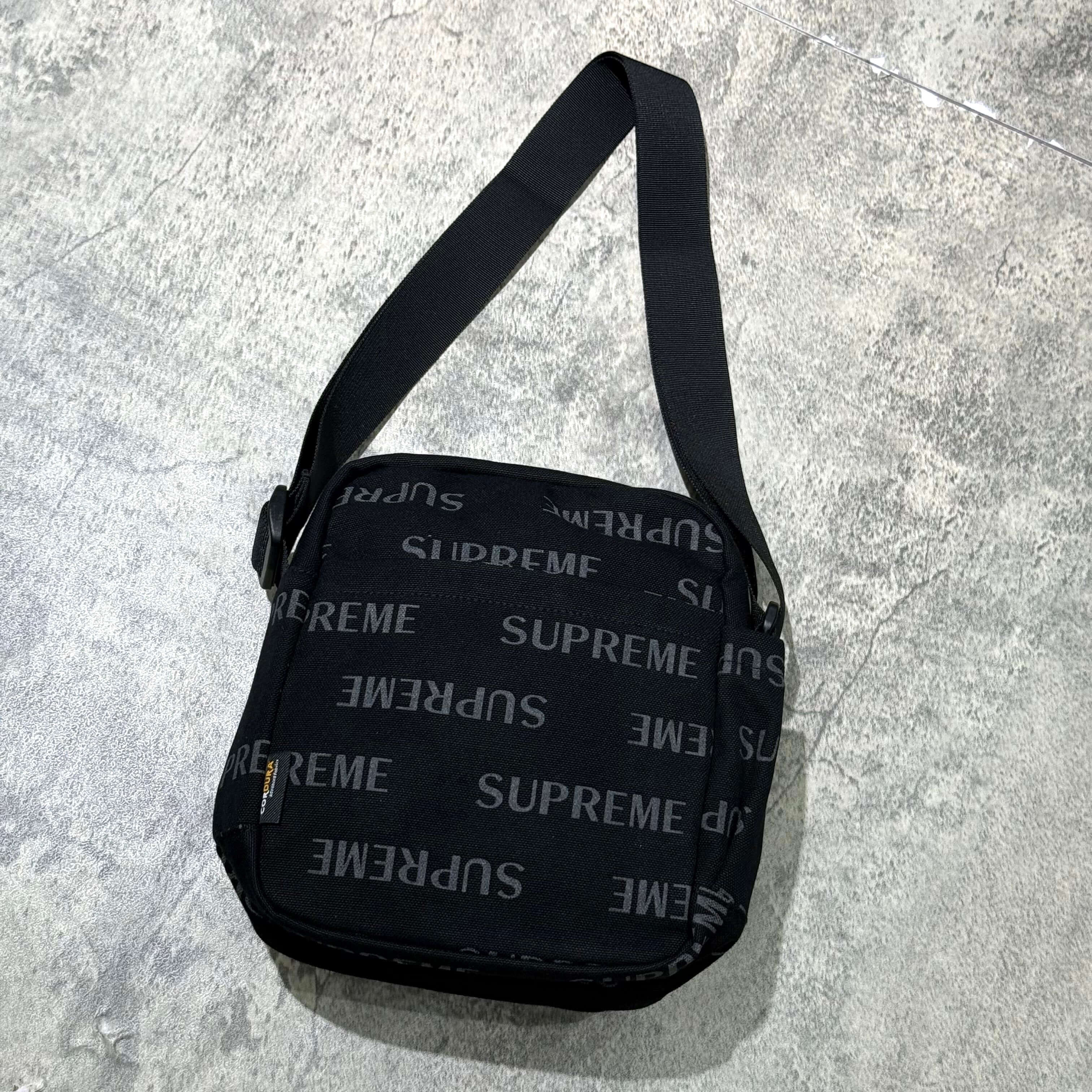 Supreme FW26 Shoulder Bag featuring a sleek black design with the Supreme logo prominently displayed.