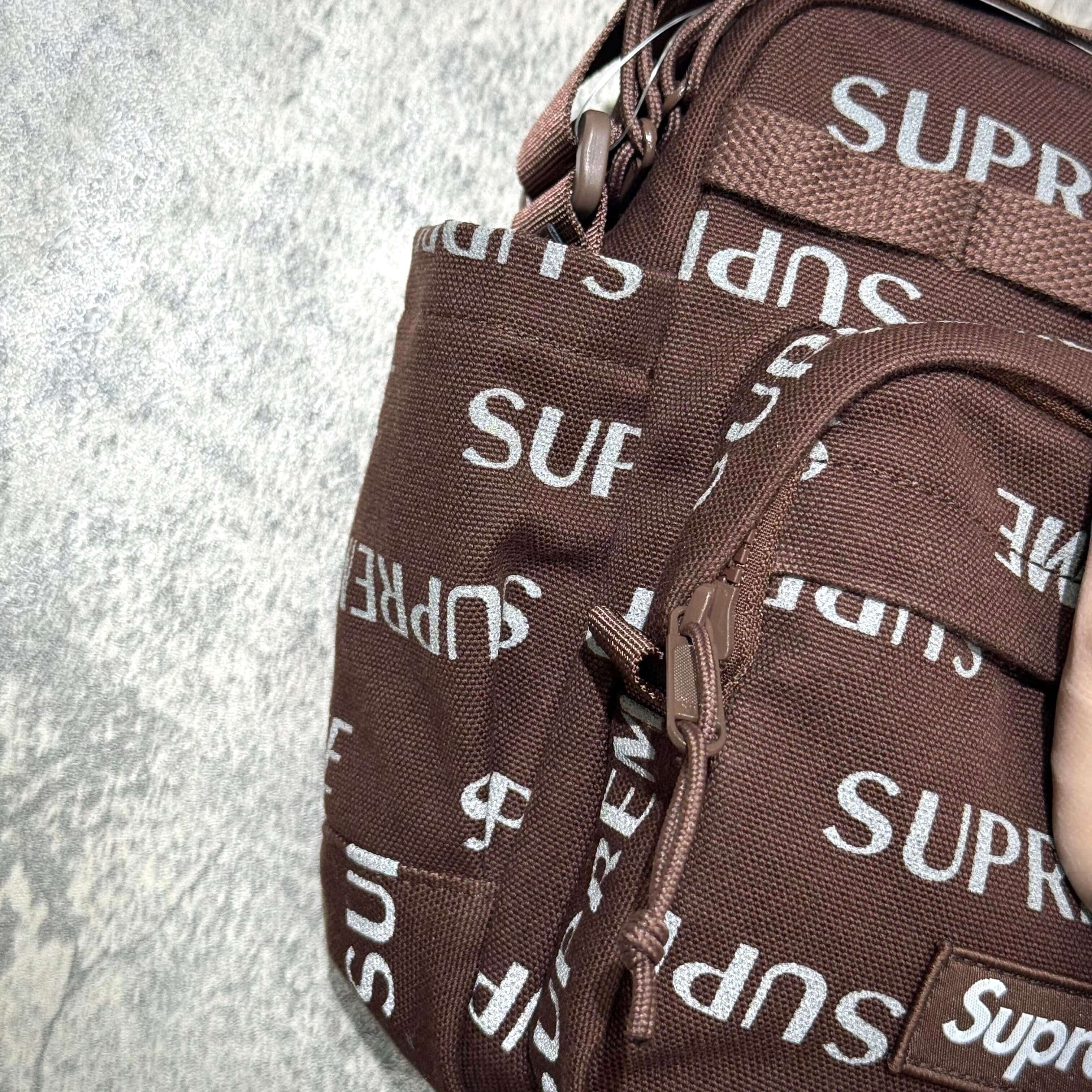 Close-up view of the Supreme FW26 Shoulder Bag featuring the signature SUPREME logo design.