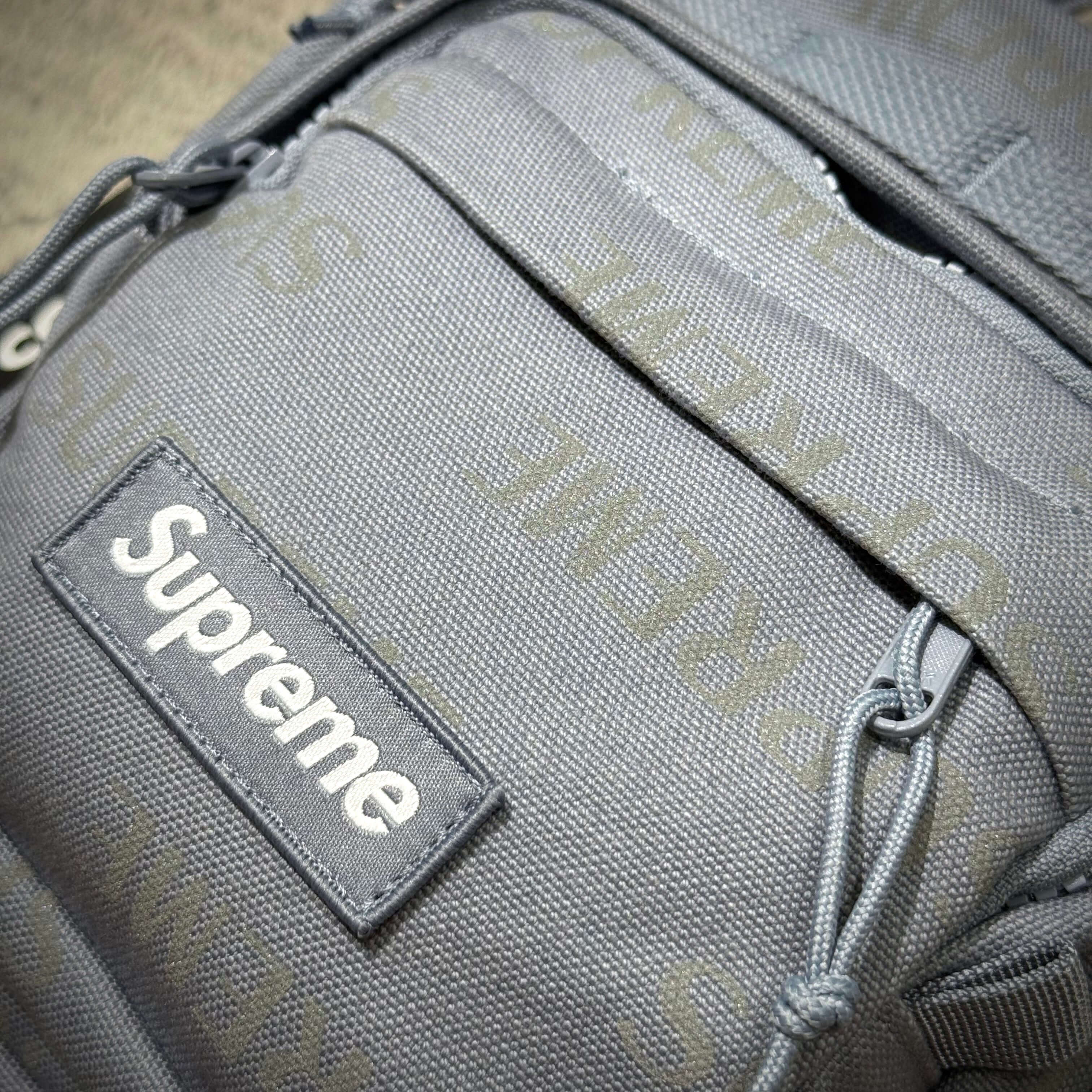Close-up of the Supreme FW26 Shoulder Bag showcasing its gray fabric and logo.