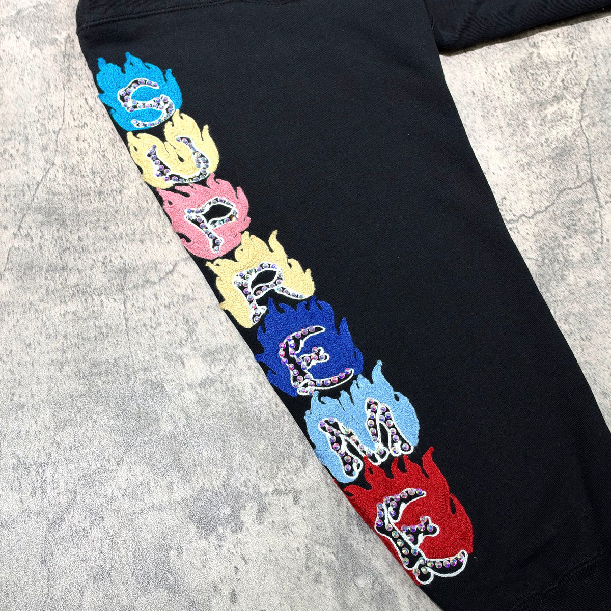 Supreme Fuck You Zip Up Hooded Sweatshirt featuring colorful flame design on black fabric.