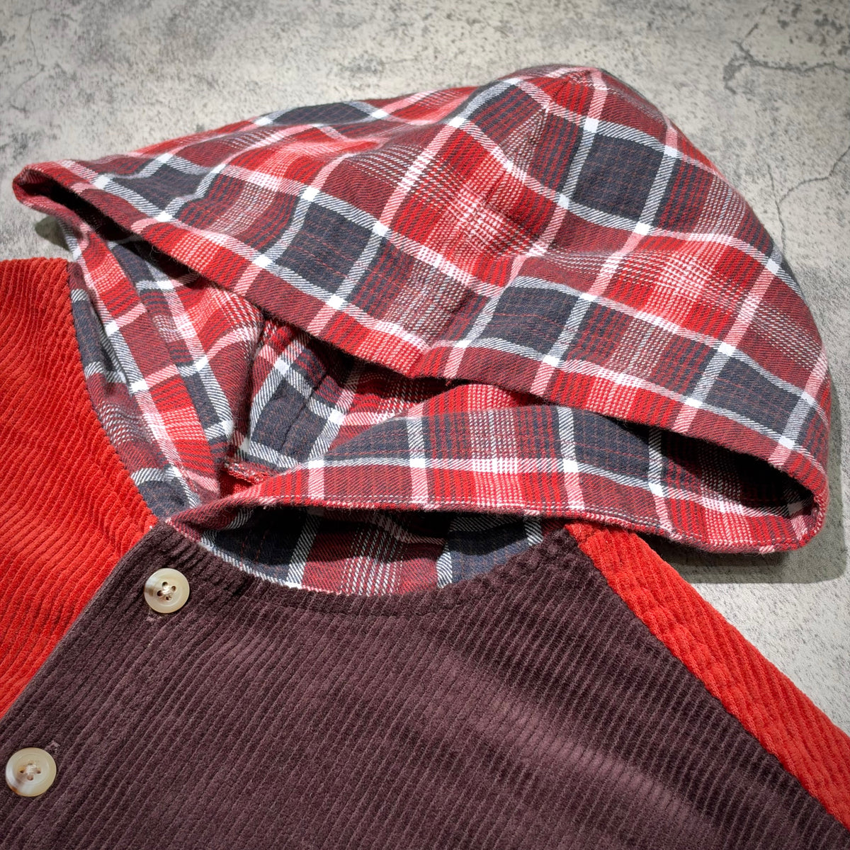 Supreme Hooded Color Blocked Corduroy Shirt showcasing red and plaid hood with button details.