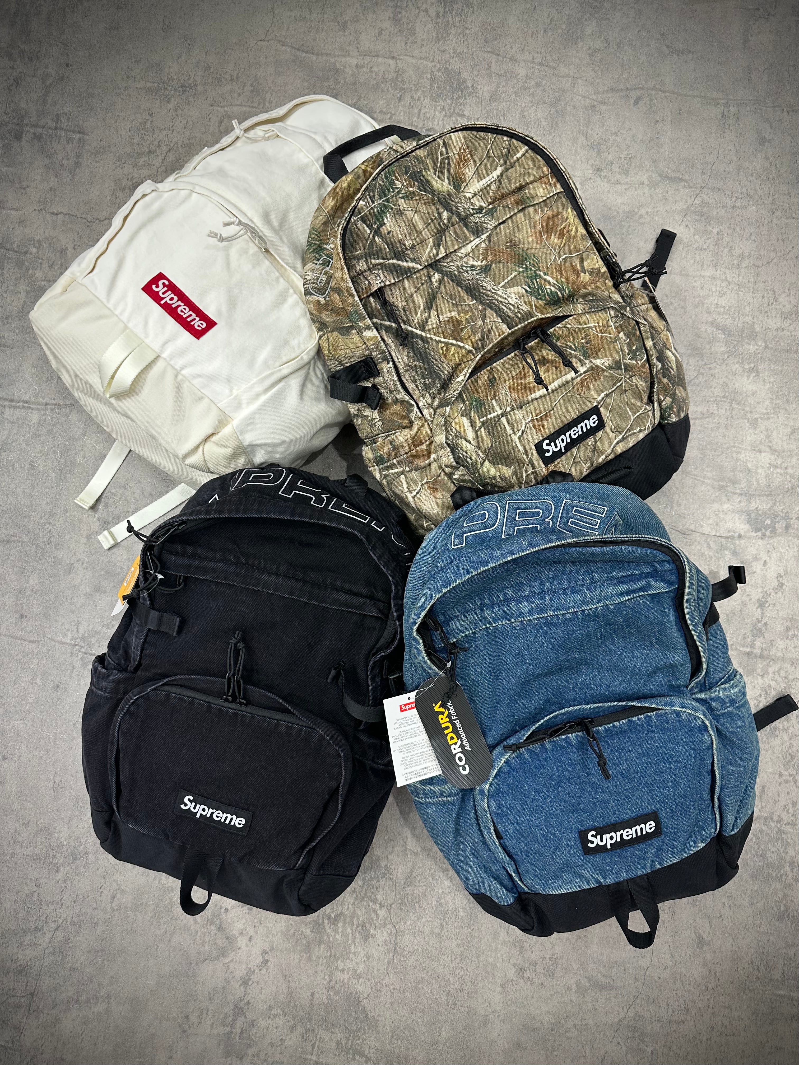 Supreme Denim Backpack FW25 washed indigo black realtree camo white