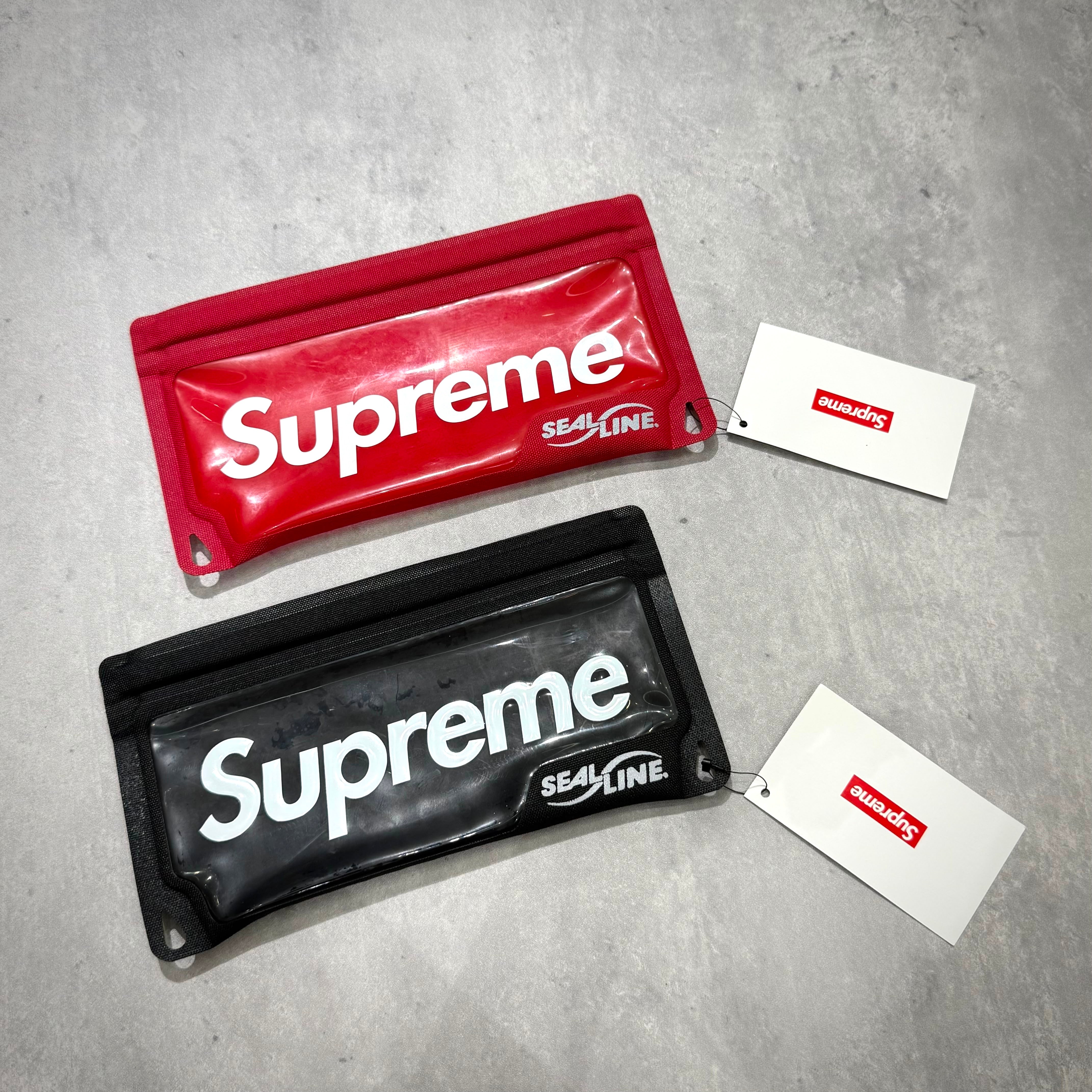 Supreme SealLine Waterproof Case in red and black with tags, showcasing stylish and functional design for outdoor use.