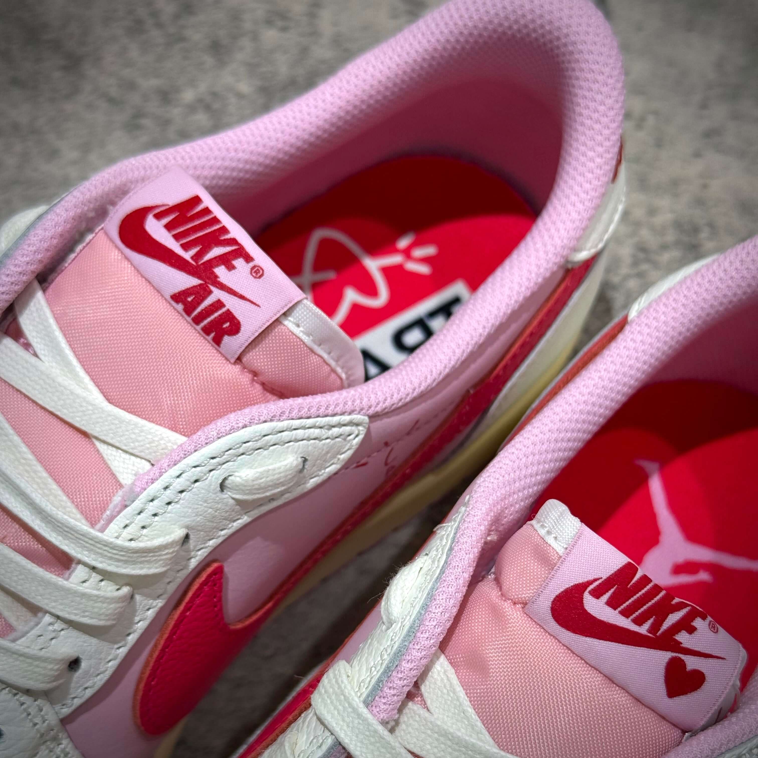 Close-up view of the Travis Scott × Nike Air Jordan 1 Retro Low SP - Tropical Pink showing the pink and white design details.
