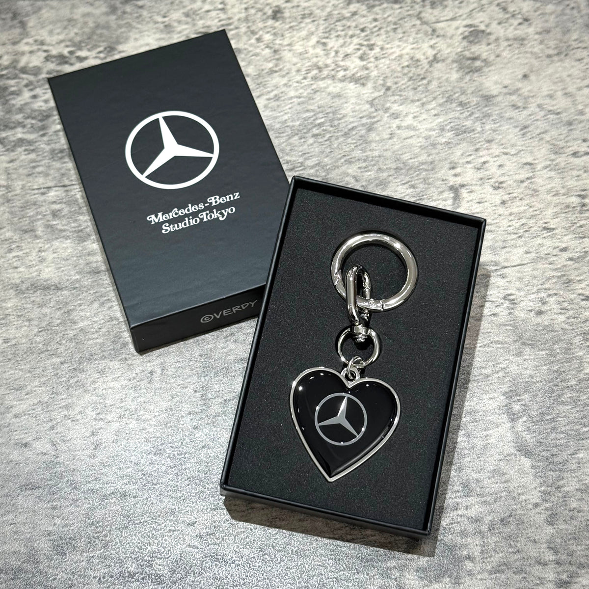 VERDY x Mercedes-Benz STUDIO TOKYO Keyring in its packaging, featuring a heart design and the Mercedes-Benz logo.