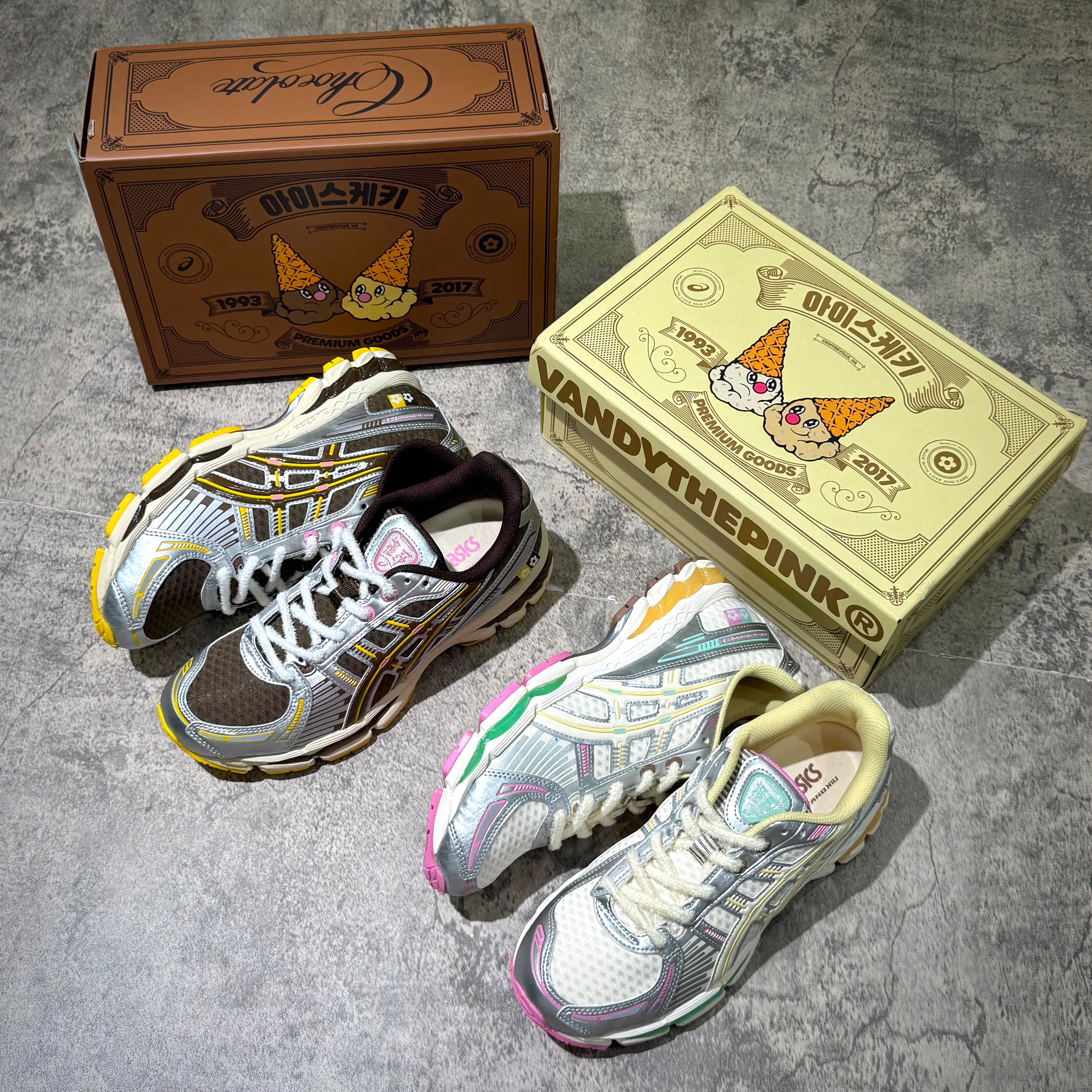 Vandy The Pink x Asics Gel-Kayano 12.1 shoes displayed with collectible boxes, featuring Antique White and Desert Palm colorway.