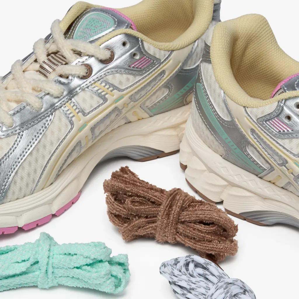 Vandy The Pink x Asics Gel-Kayano 12.1 - Antique White sneakers with colorful laces options next to them.