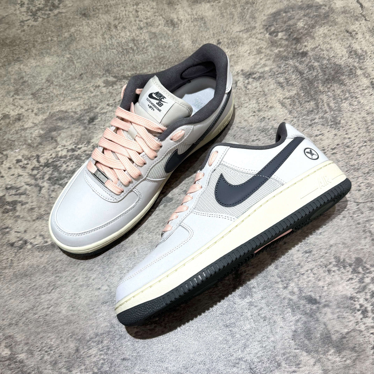 Yuto Horigome x Nike SB Air Force 1 Low IO8439-100 featuring a light grey design with black and pink accents.