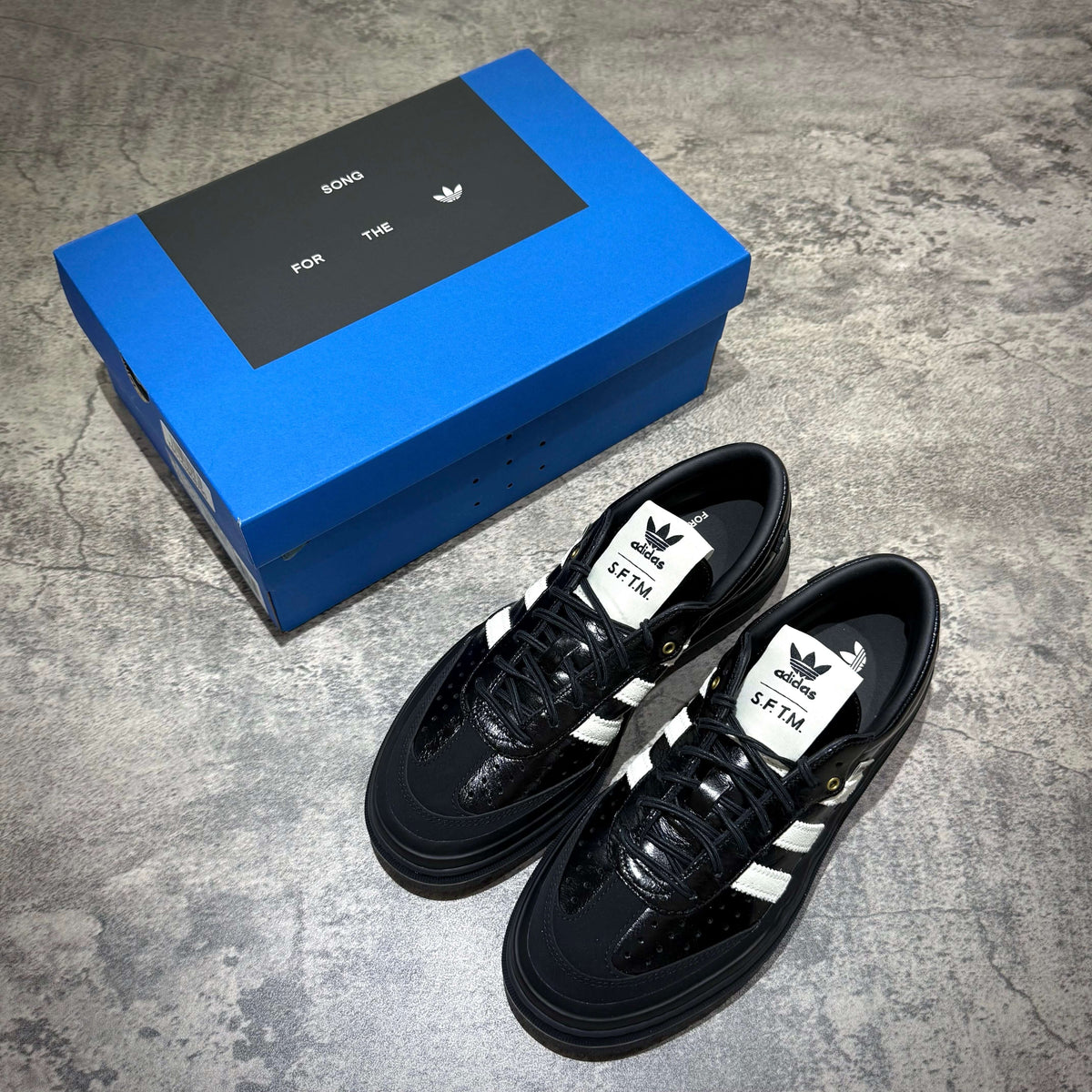 adidas Samba LX Freizeit x Song For The Mute shoes displayed next to their blue box.