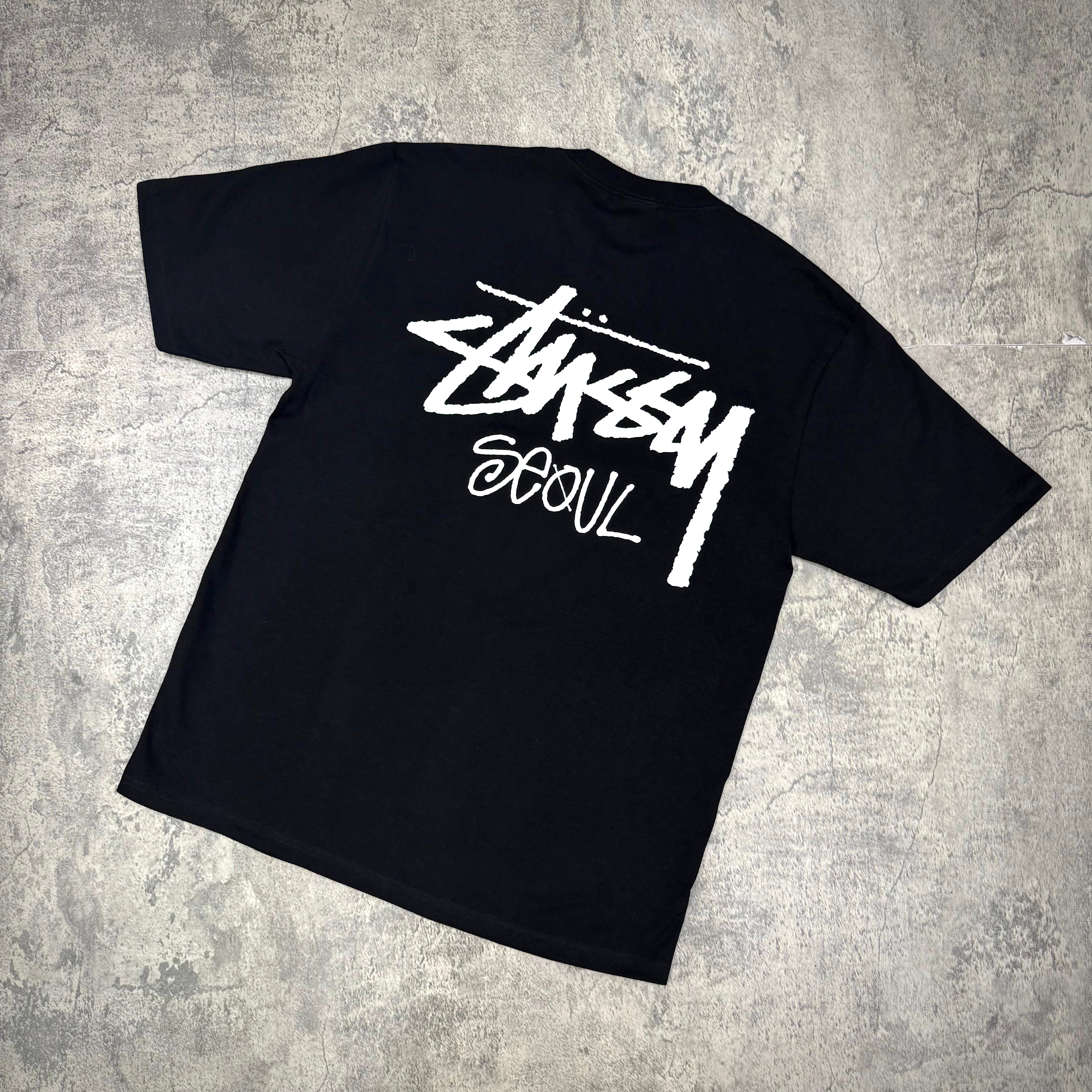 Stussy Seoul Exclusive Logo Tee in black featuring a bold Stussy Seoul logo on the back.
