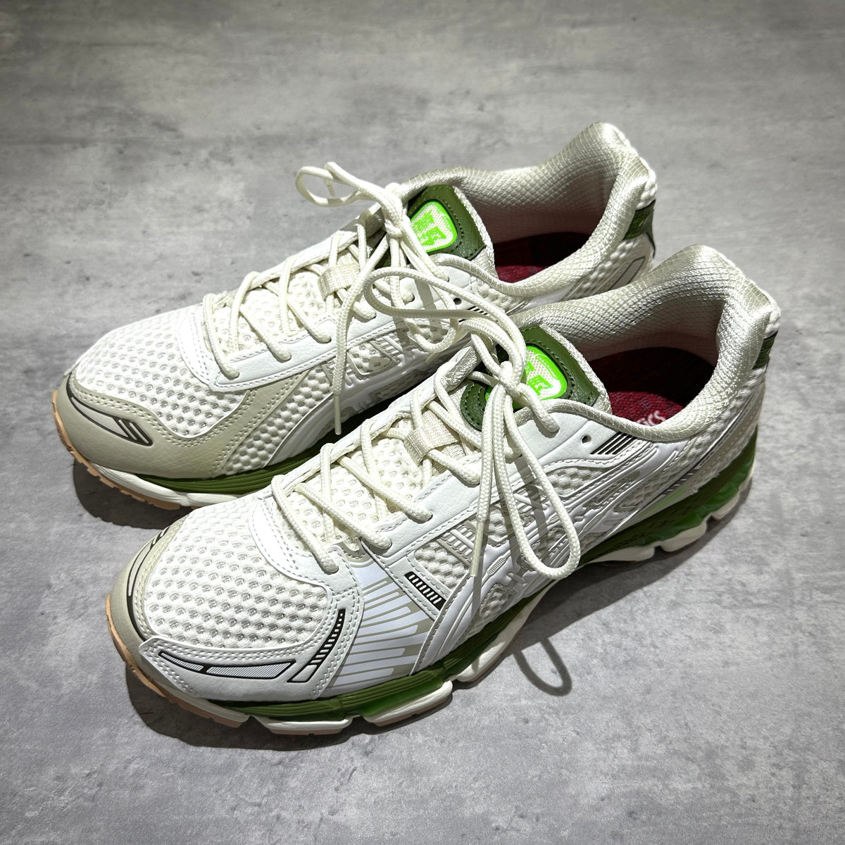 atmos x Asics Gel-Kayano 12.1 Archipelago in white and green colorway, showcasing top view of stylish running shoes.