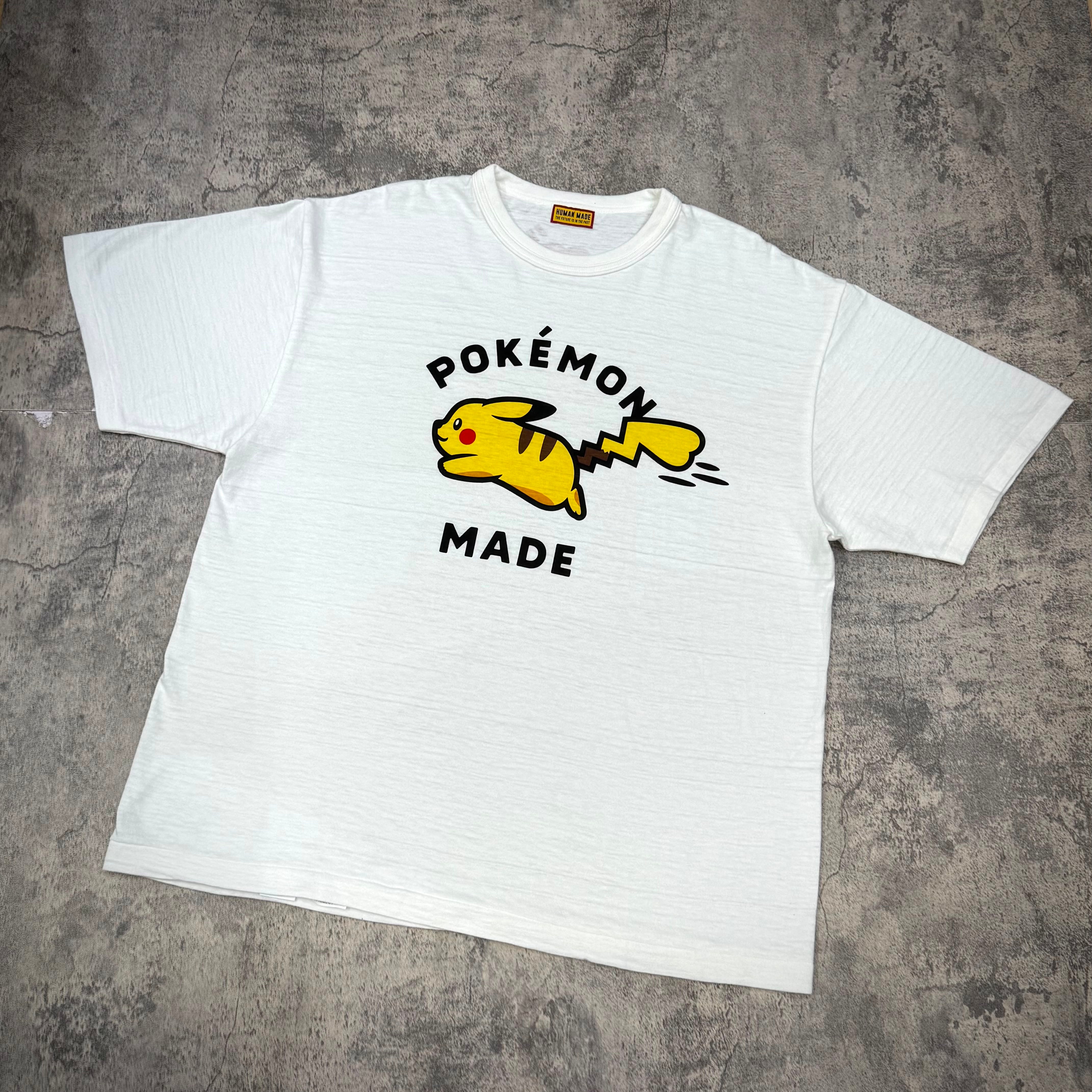 Human Made x Pokemon Graphic Tee featuring Pikachu design in vibrant colors on a white background.