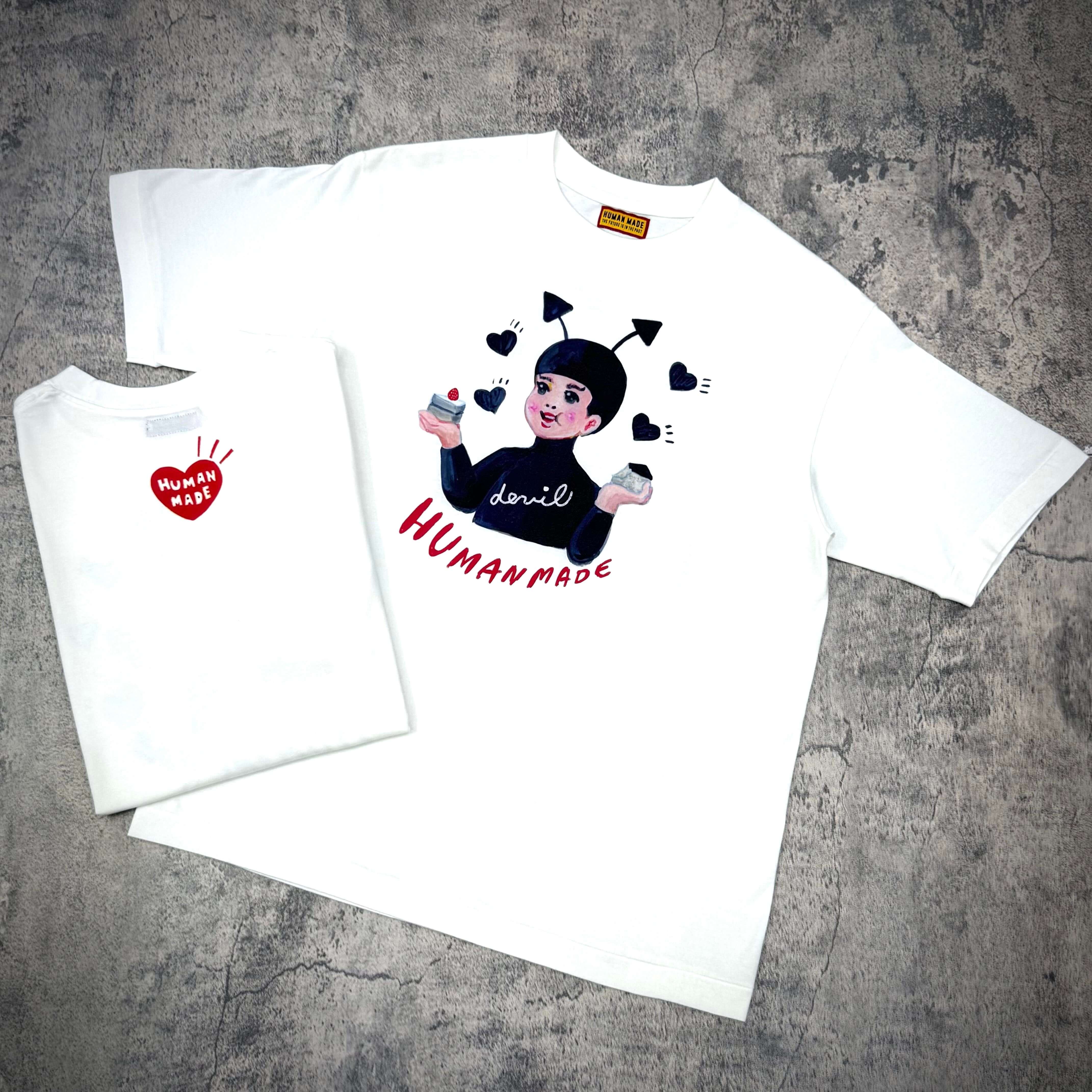 Human Made Keiko Sootome "Angel vs Demon" Tee featuring playful graphic design on a white shirt.