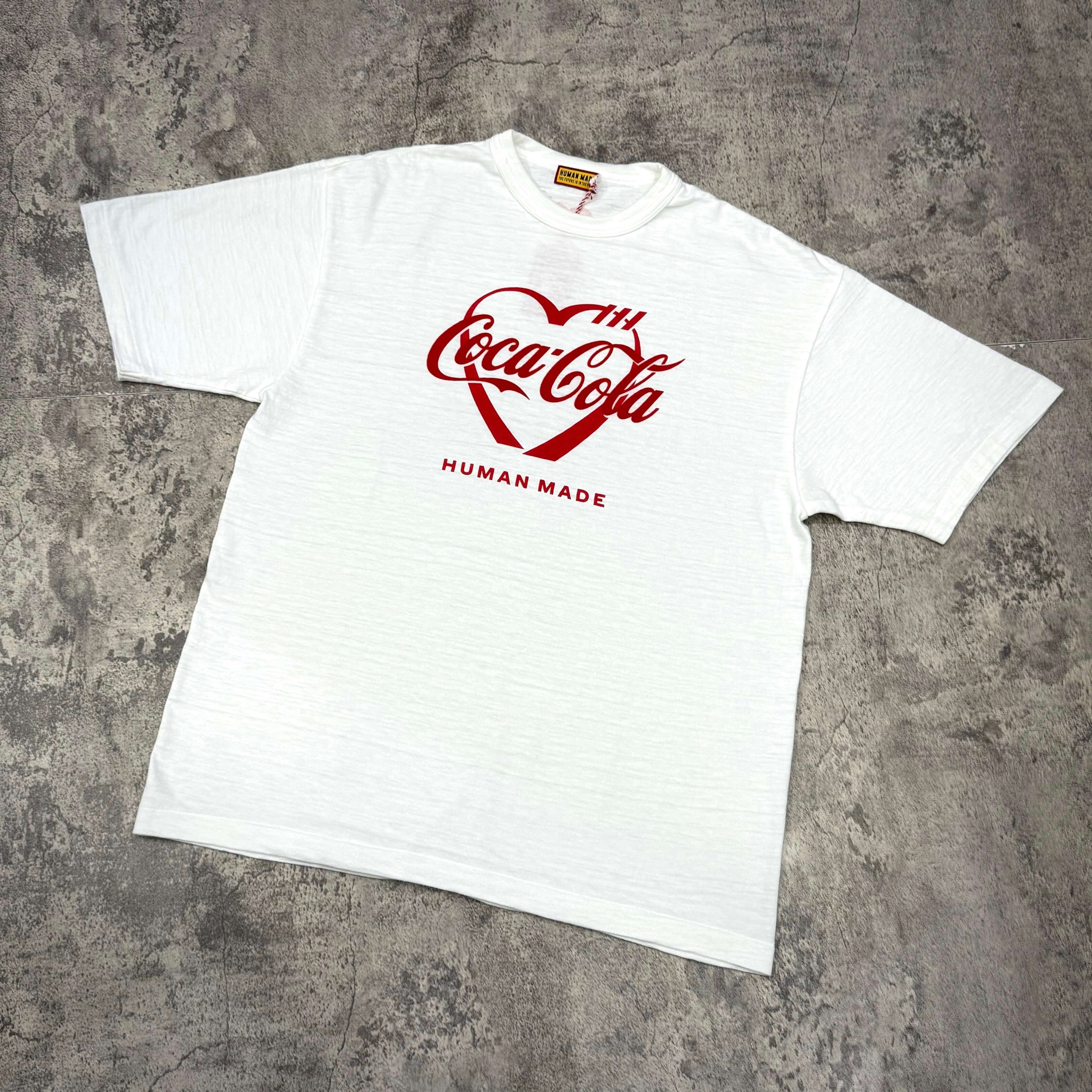 Human Made Coca Cola graphic tee featuring a heart design, available in white, perfect for casual wear.