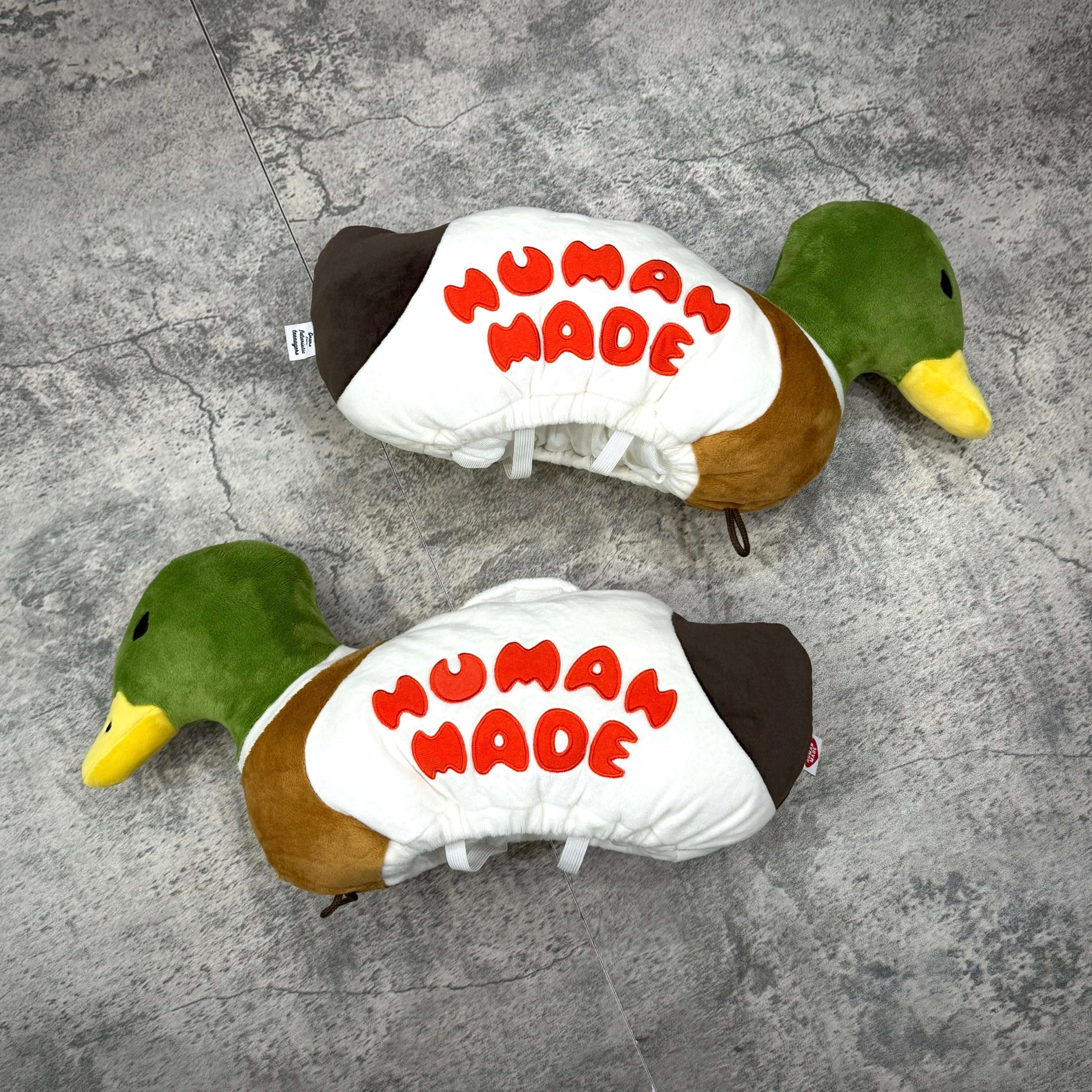 Human Made Duck Plush Doll Tissue Case displayed on a textured surface, showcasing colorful design and soft materials.