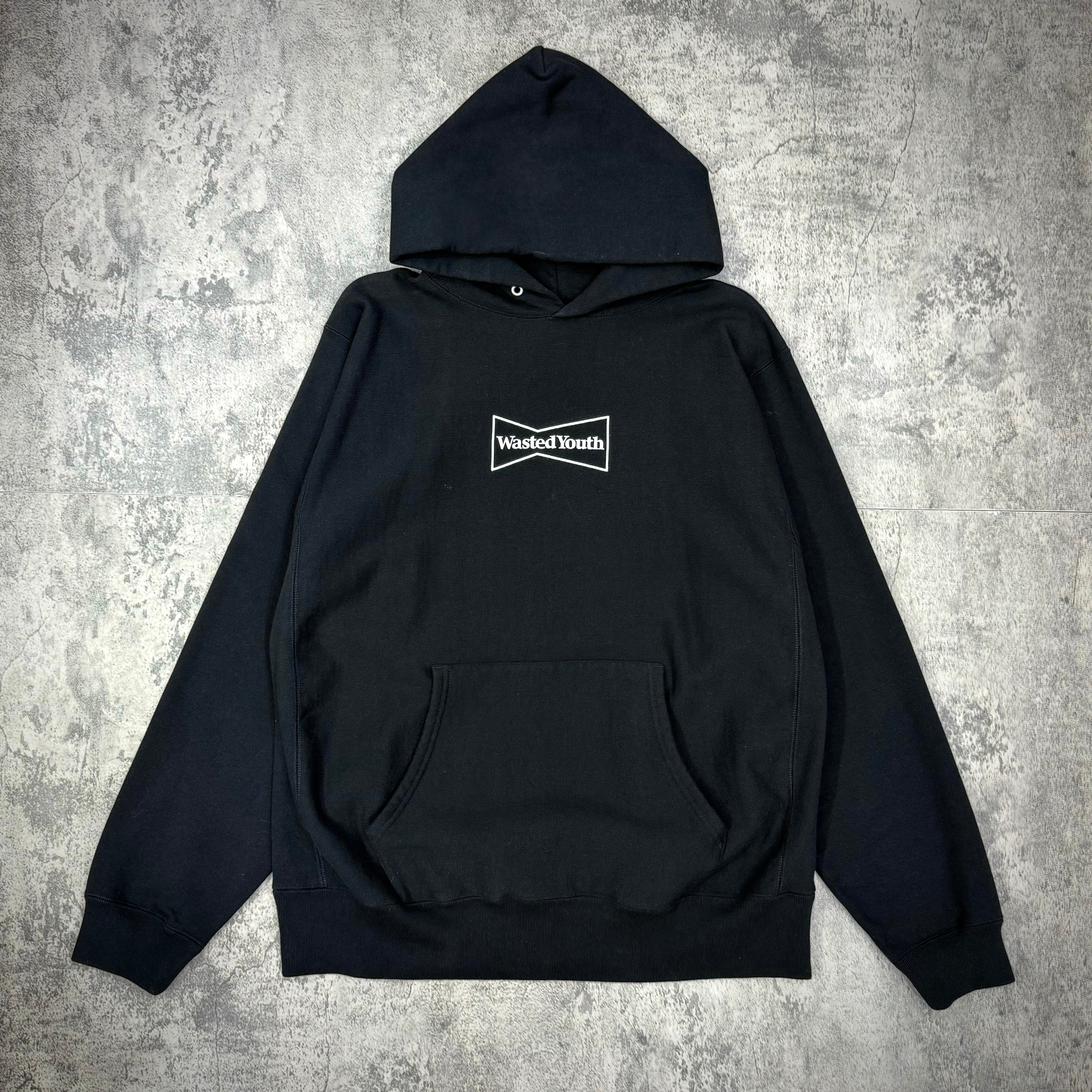 Wasted Youth Hoodie - Black, front view, featuring logo and kangaroo pocket, stylish streetwear garment.
