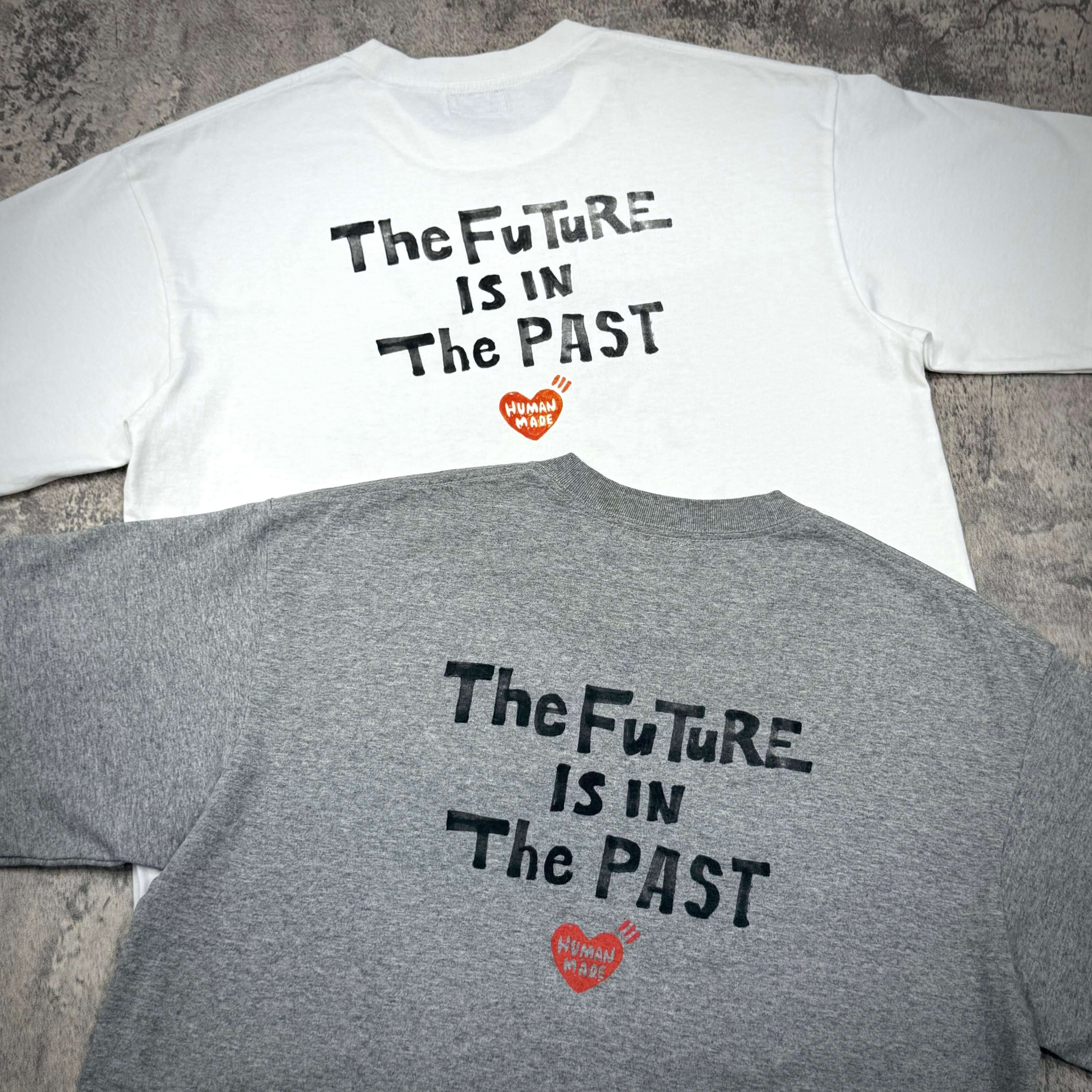 Human Made Graphic Tee HM31CS009 featuring the text 'The Future Is In The Past' on white and gray shirts