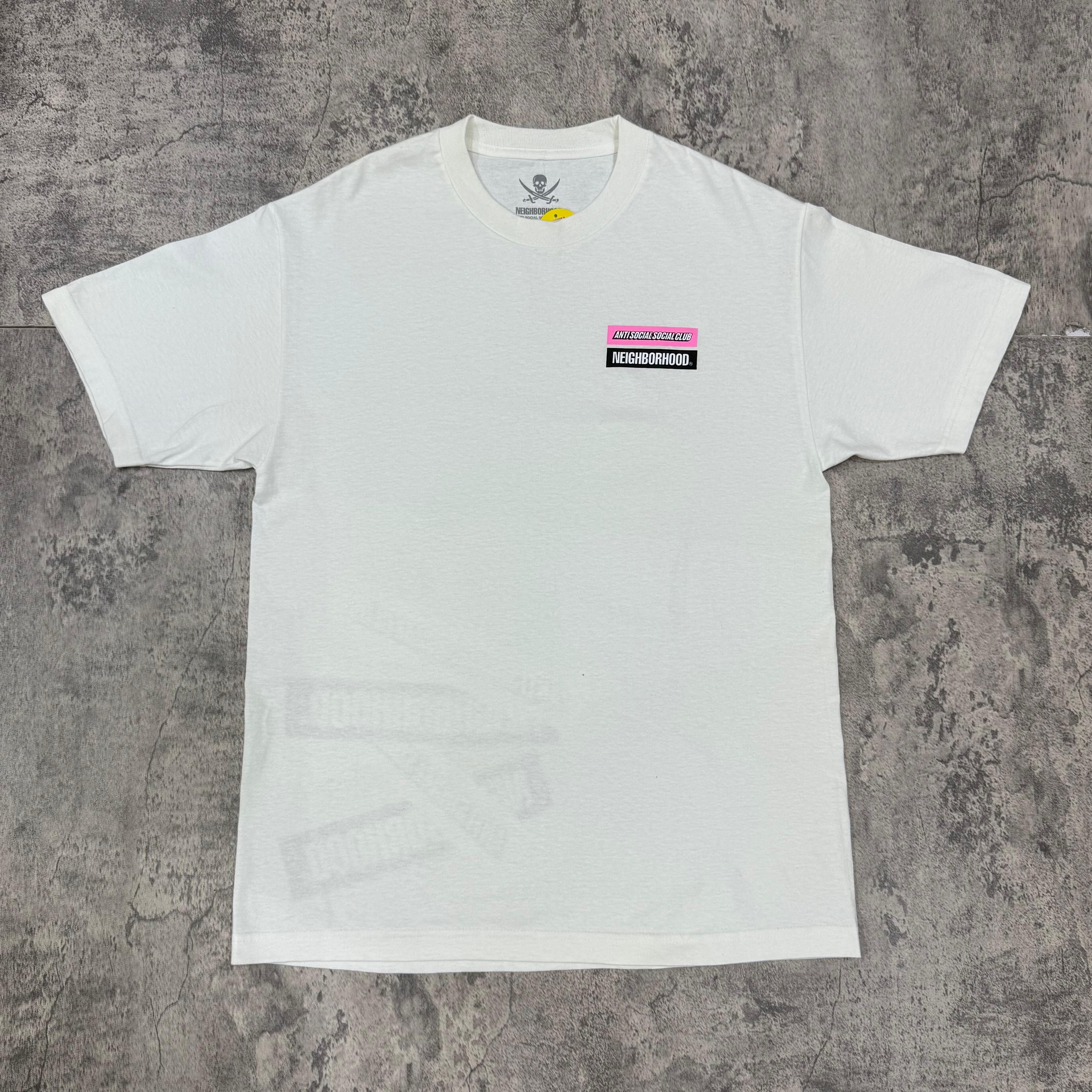 ASSC x Neighborhood Stuck On You Tee - Black / White on a flat surface, showcasing detailed branding.