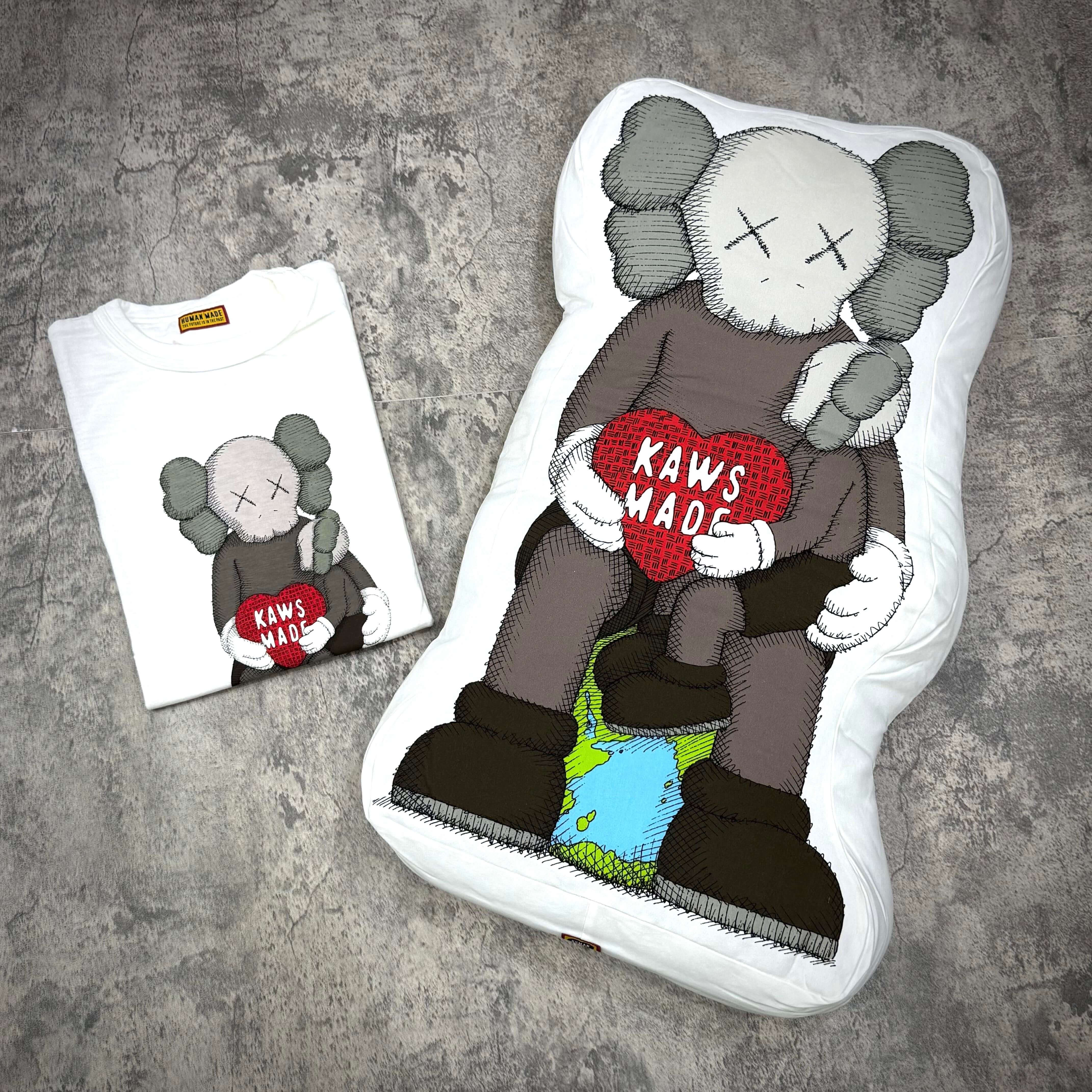 Human Made Bangkok Exclusive Kaws Made cushion featured with Kaws Made t-shirt on a textured background.