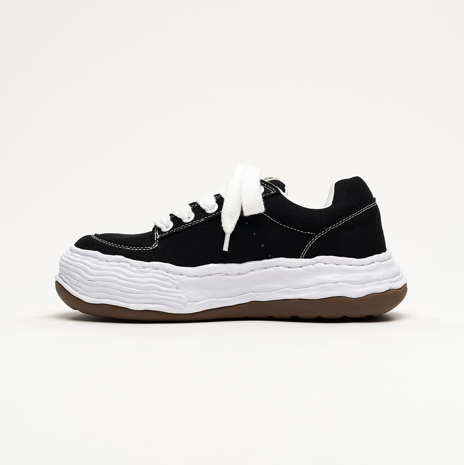 MMY Oliver Canvas Low - Black sneaker with unique sole and laces, stylish footwear for casual wear.