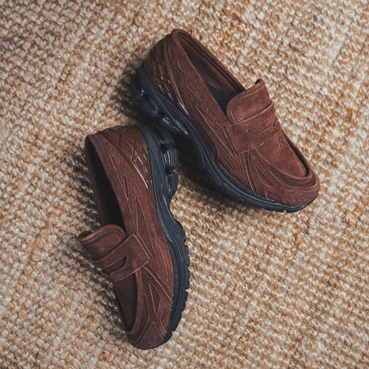 New Balance 1906L Loafer - Rich Oak displayed on a textured background, showcasing their contemporary design.