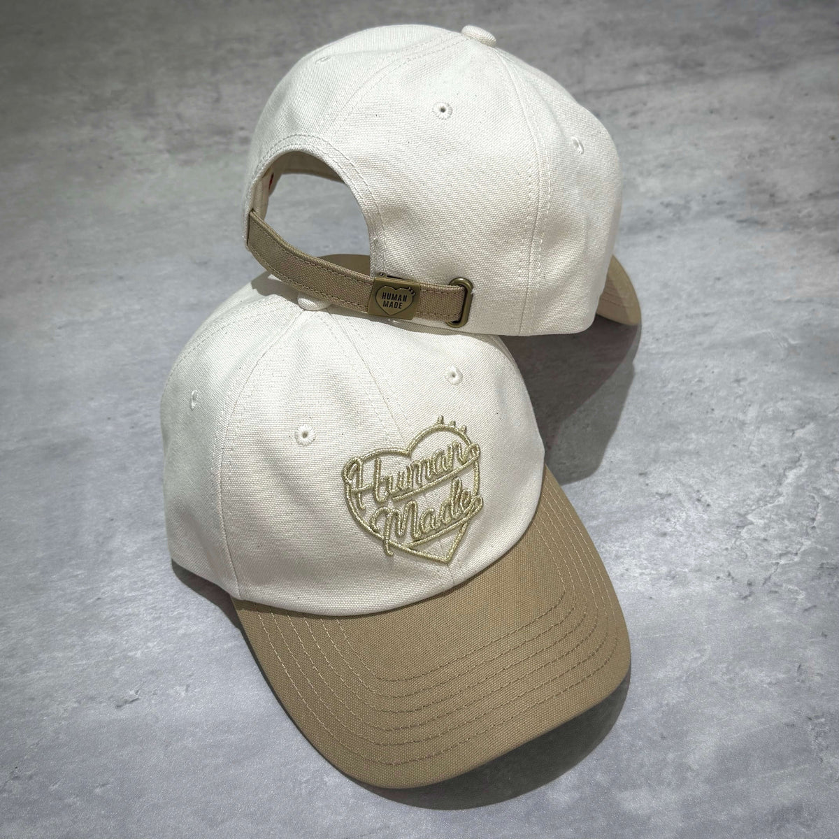 Human Made Tokyo Exclusive 6 Panel Canvas Cap featuring a cream and khaki color scheme with embroidered logo.
