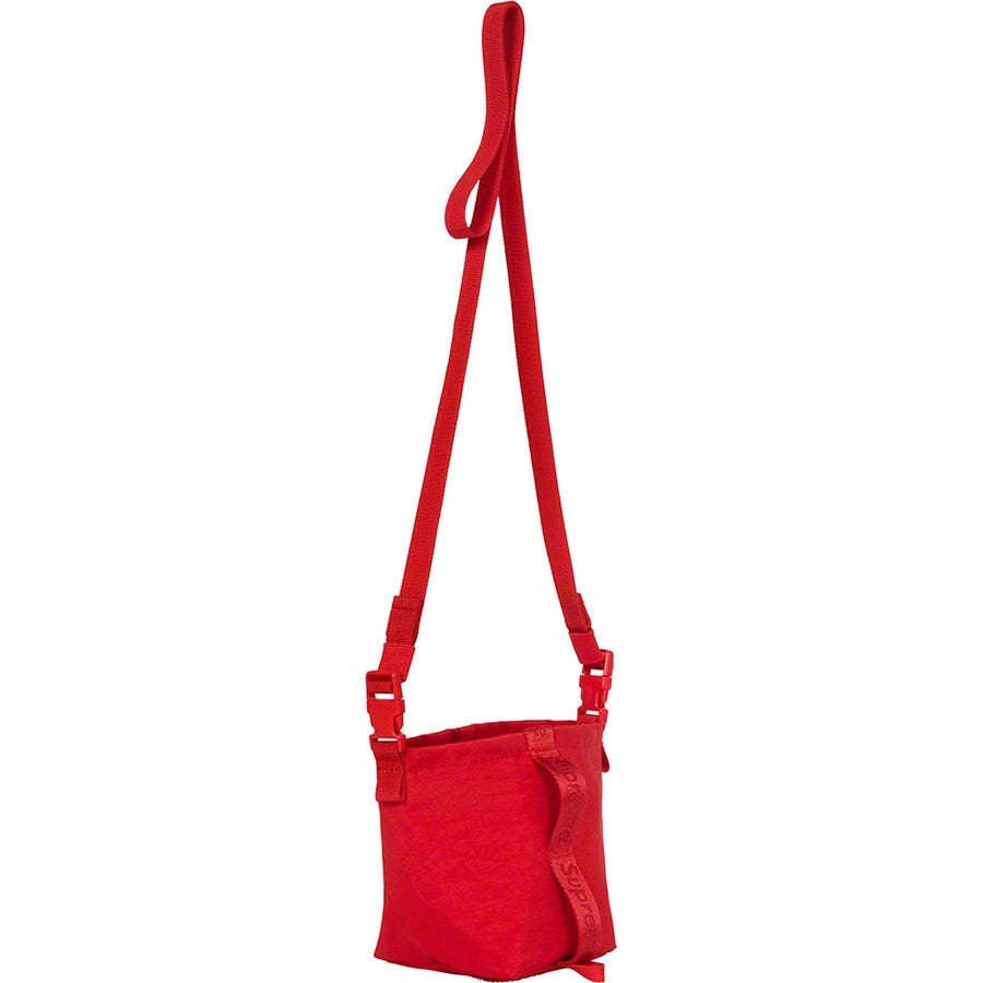 Supreme Neck Pouch FW20 - Dark Red with adjustable strap hanging against a white background.